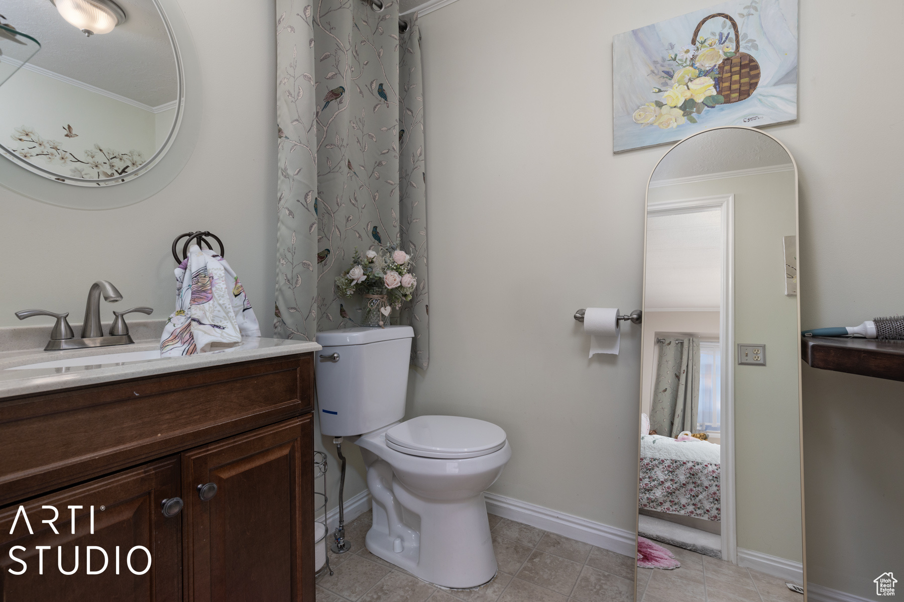 Bathroom featuring vanity, ornamental molding, tile patterned flooring, and toilet