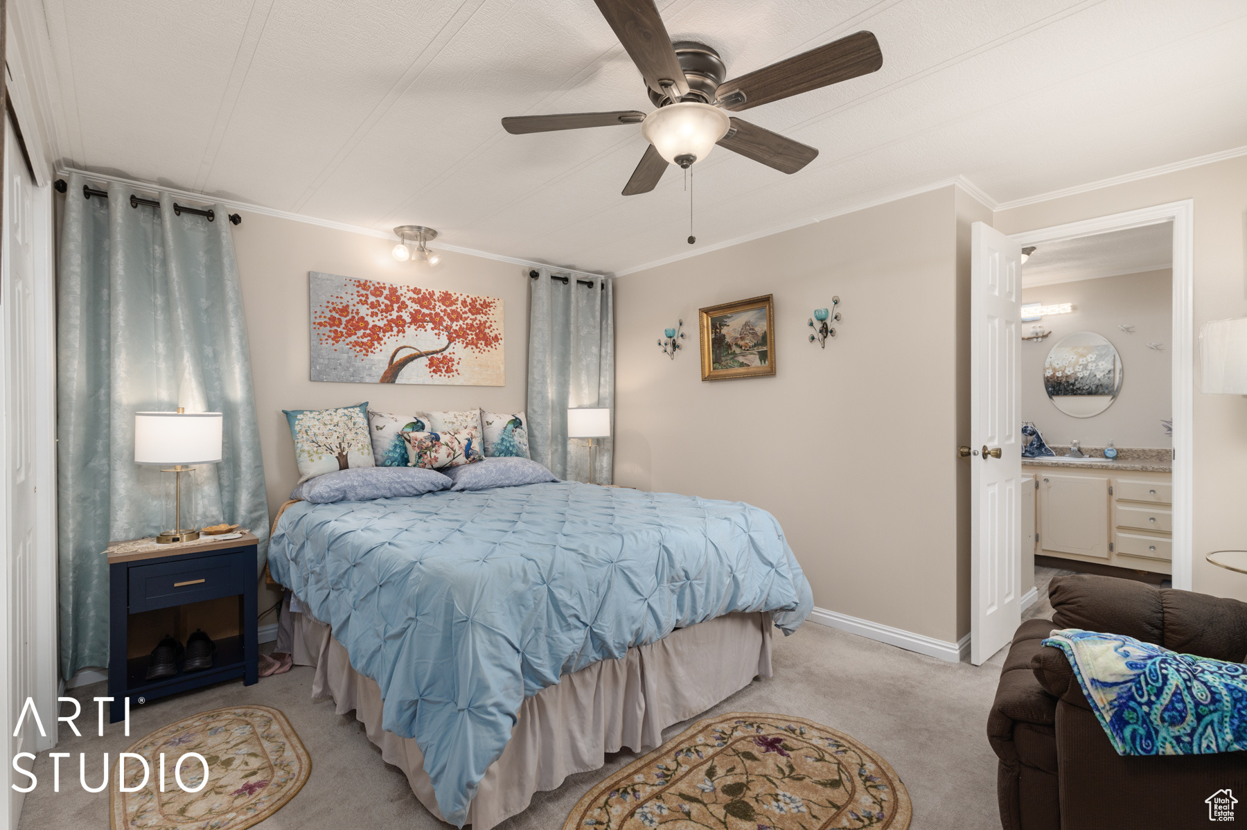 Bedroom featuring ensuite bathroom, sink, light colored carpet, ceiling fan, and ornamental molding