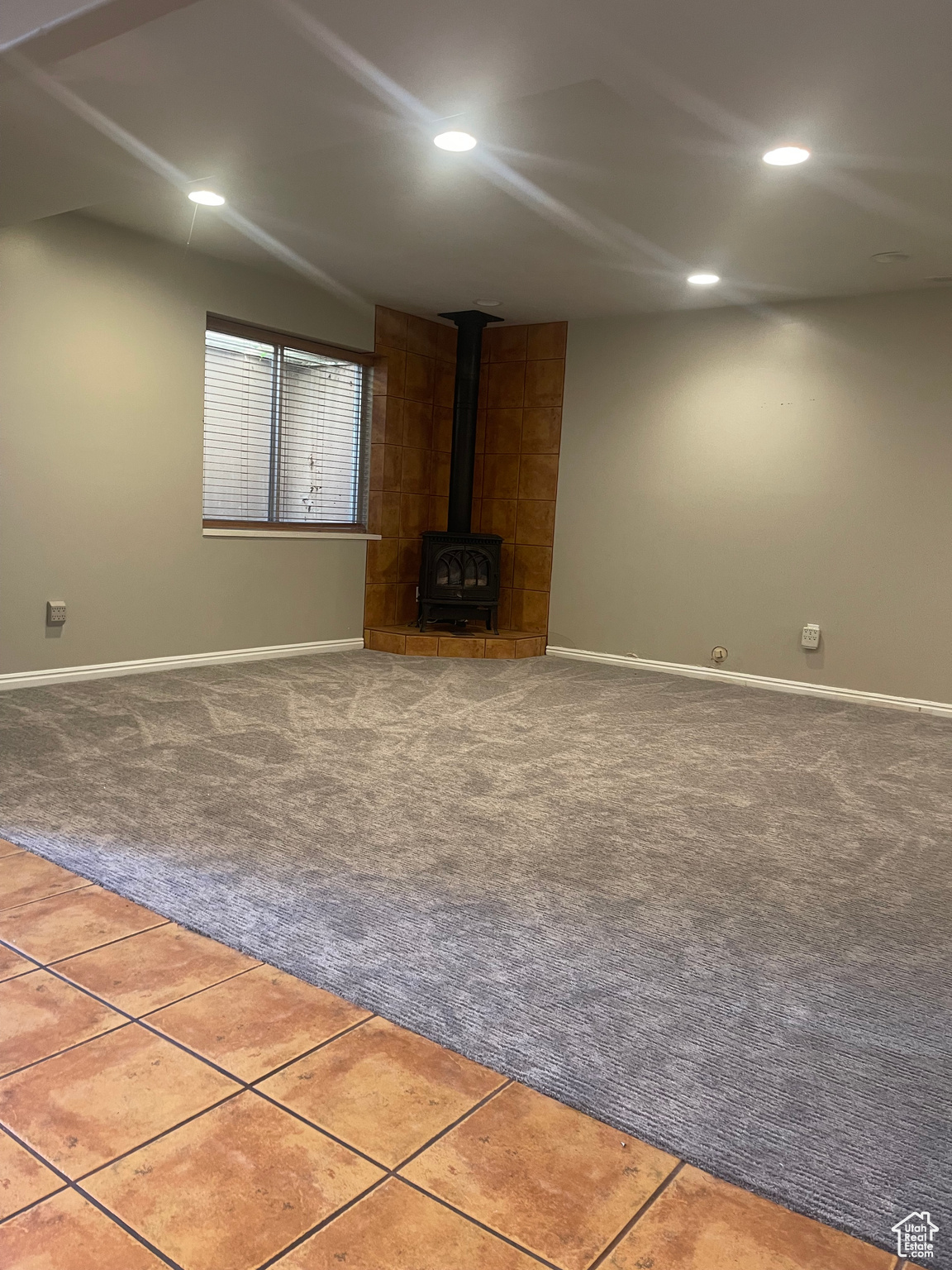 Family room with carpet floors and a gas fireplace!