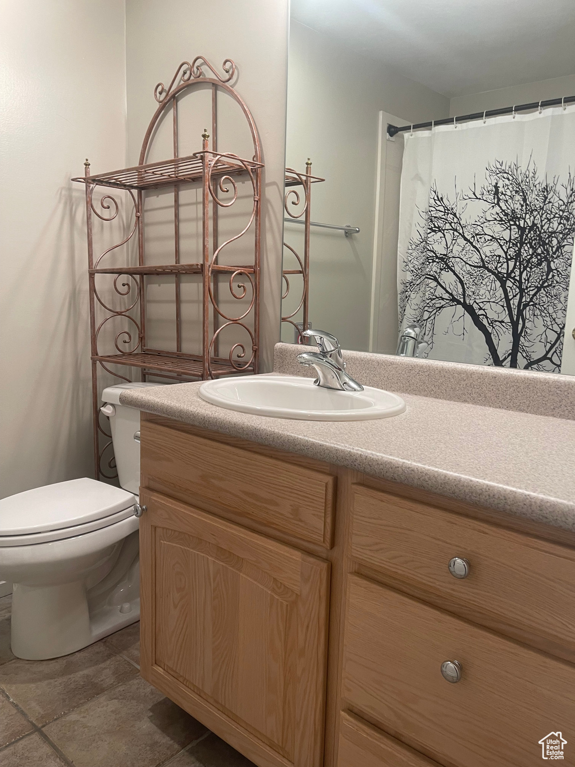 Bathroom with vanity, tile patterned flooring, and toilet