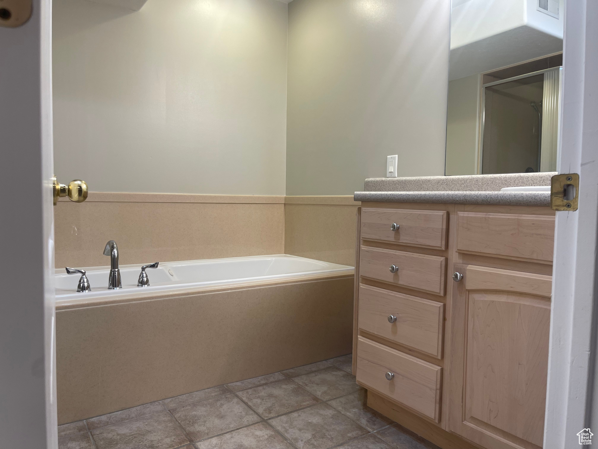 Primary Bathroom with vanity, Separate Shower, tile patterned floors, and a Jetted tub to relax in