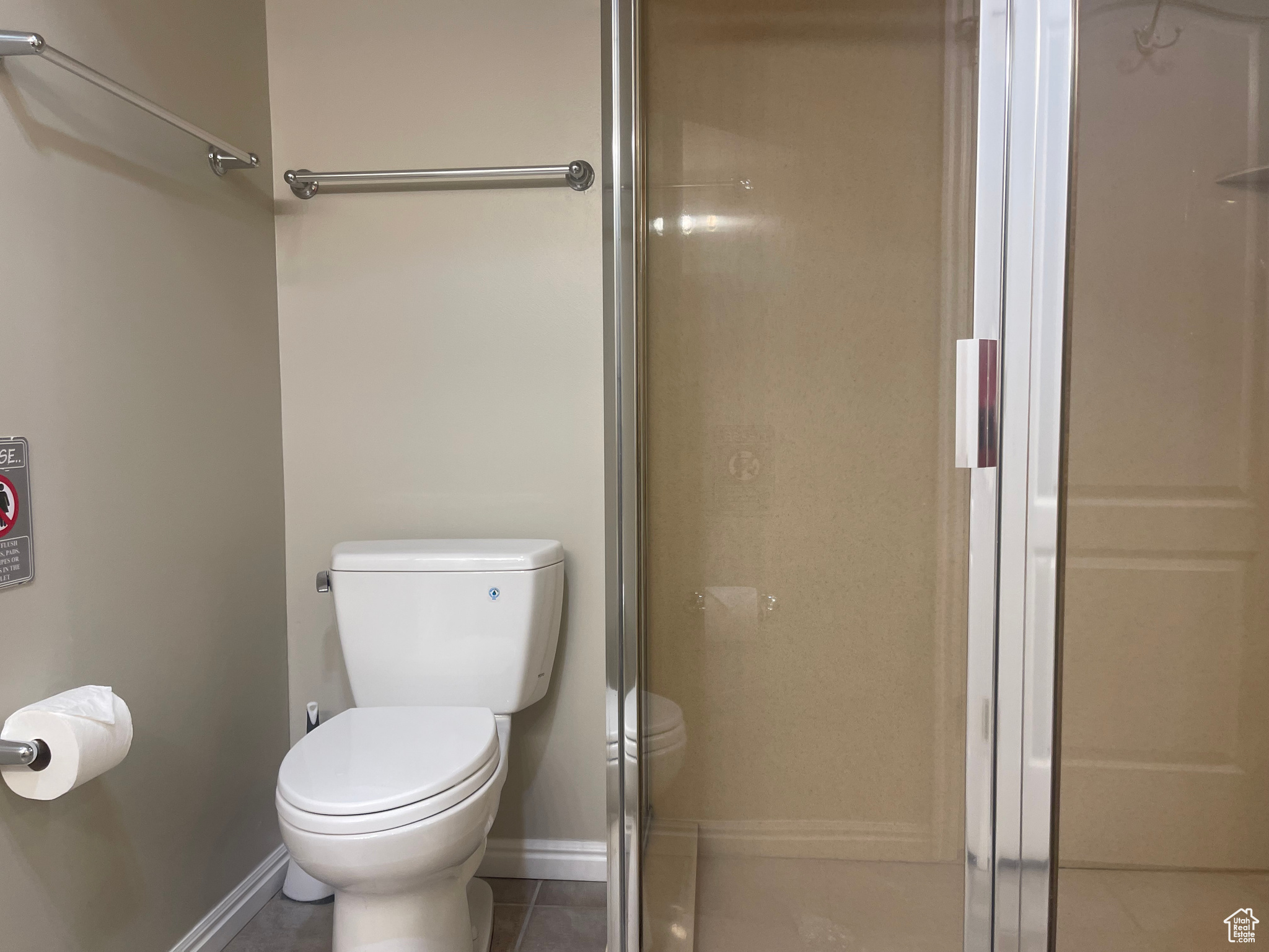 Primary Bathroom featuring tile patterned flooring and toilet