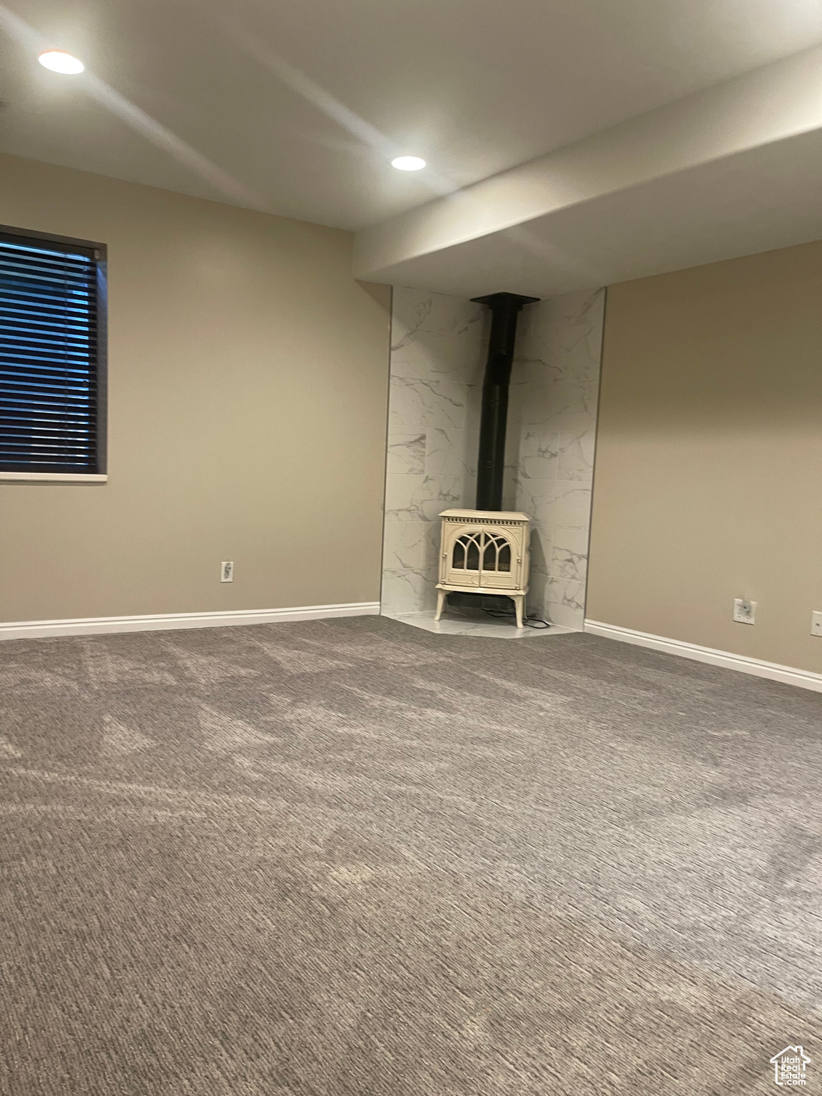 Primary bedroom featuring carpet and a gas stove