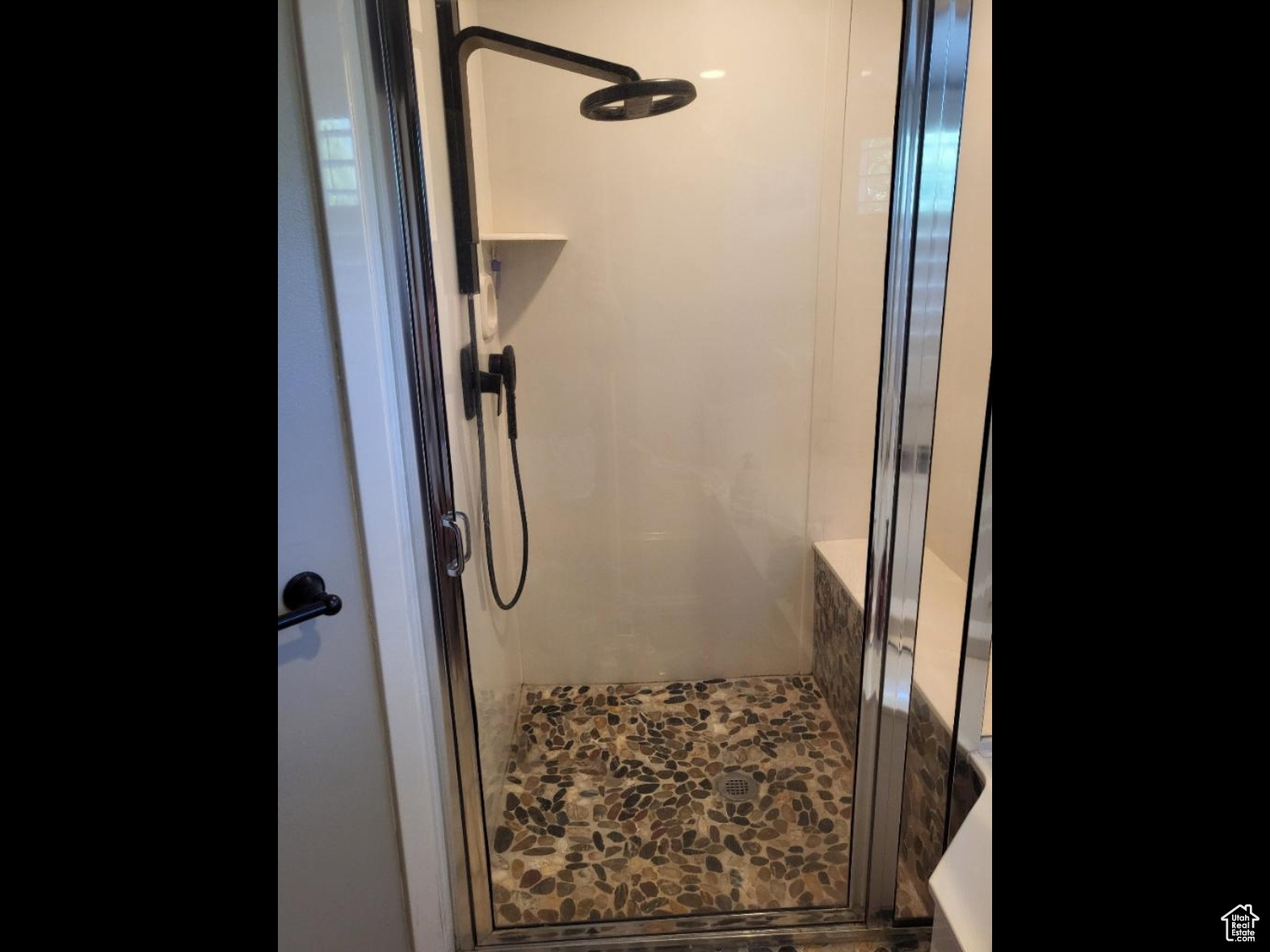 Primary bathroom stone shower with Nebia shower system