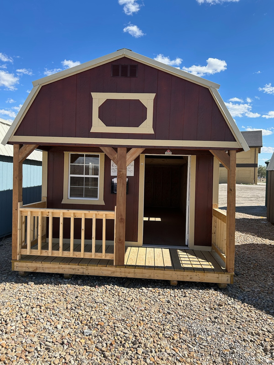 Exterior space featuring a wooden deck and an outbuilding