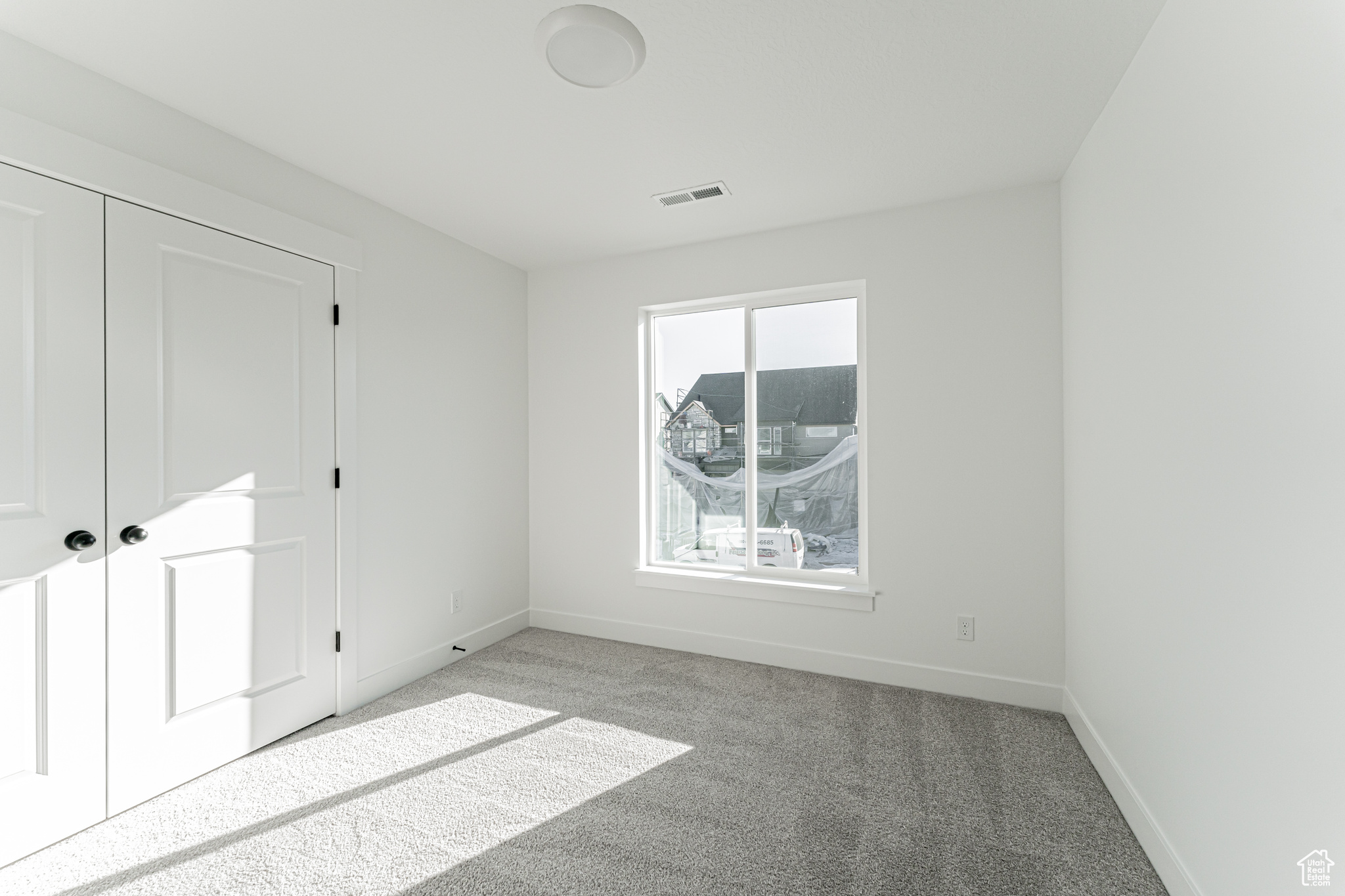 Unfurnished bedroom with carpet floors and a closet