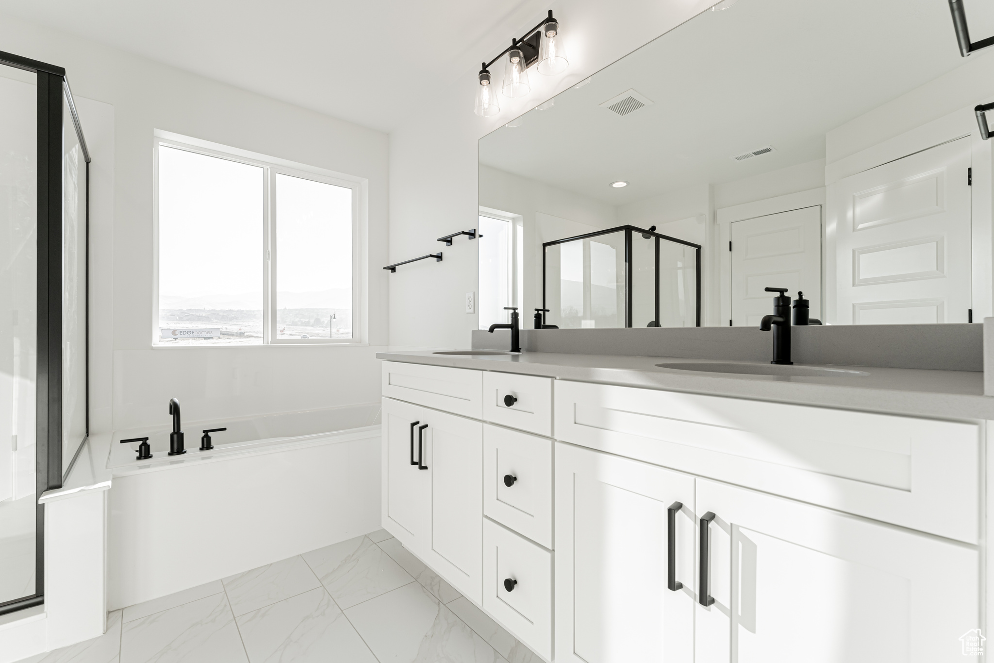 Bathroom featuring shower with separate bathtub and vanity