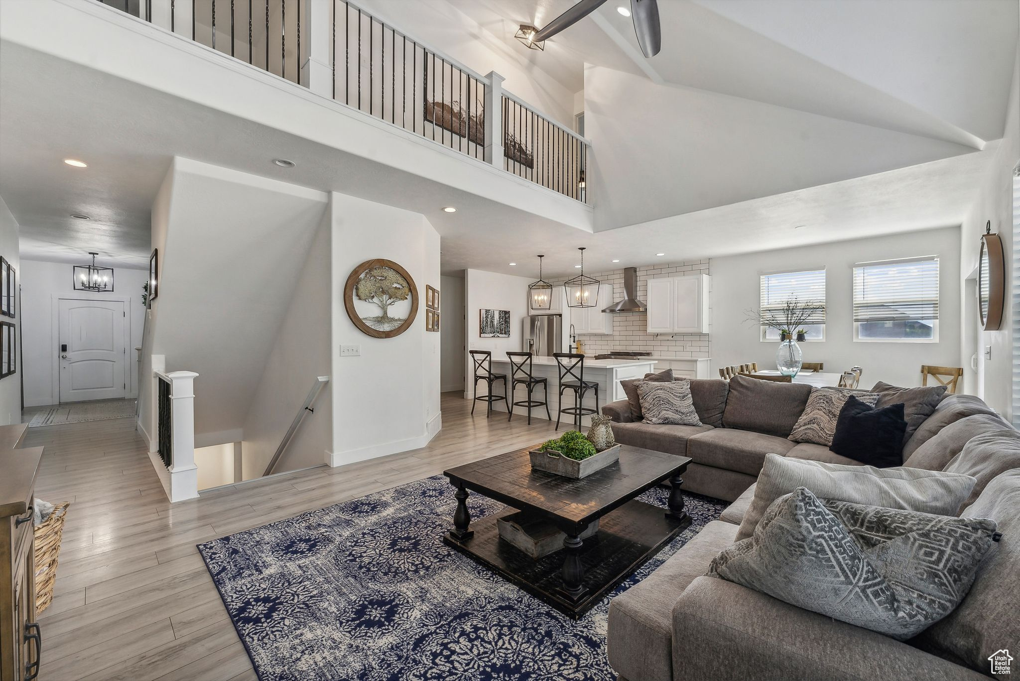 Living room featuring high vaulted ceiling and light wood-type flooring