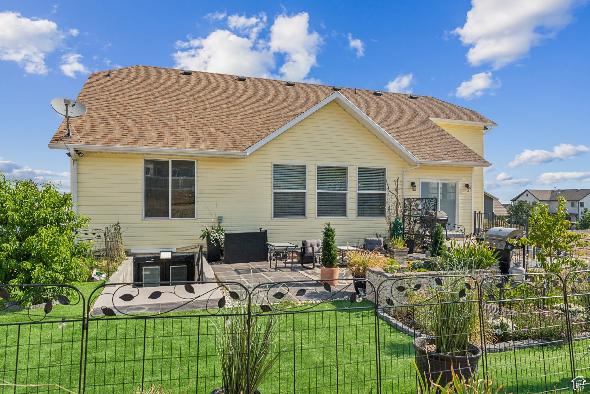 Rear view of property featuring a patio and a yard