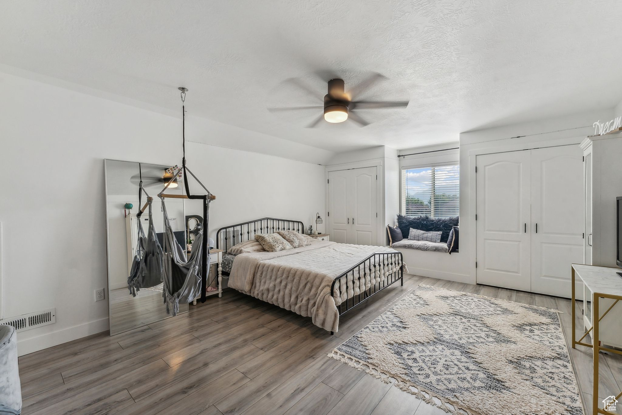 Bedroom featuring hardwood / wood-style flooring, a textured ceiling, and ceiling fan