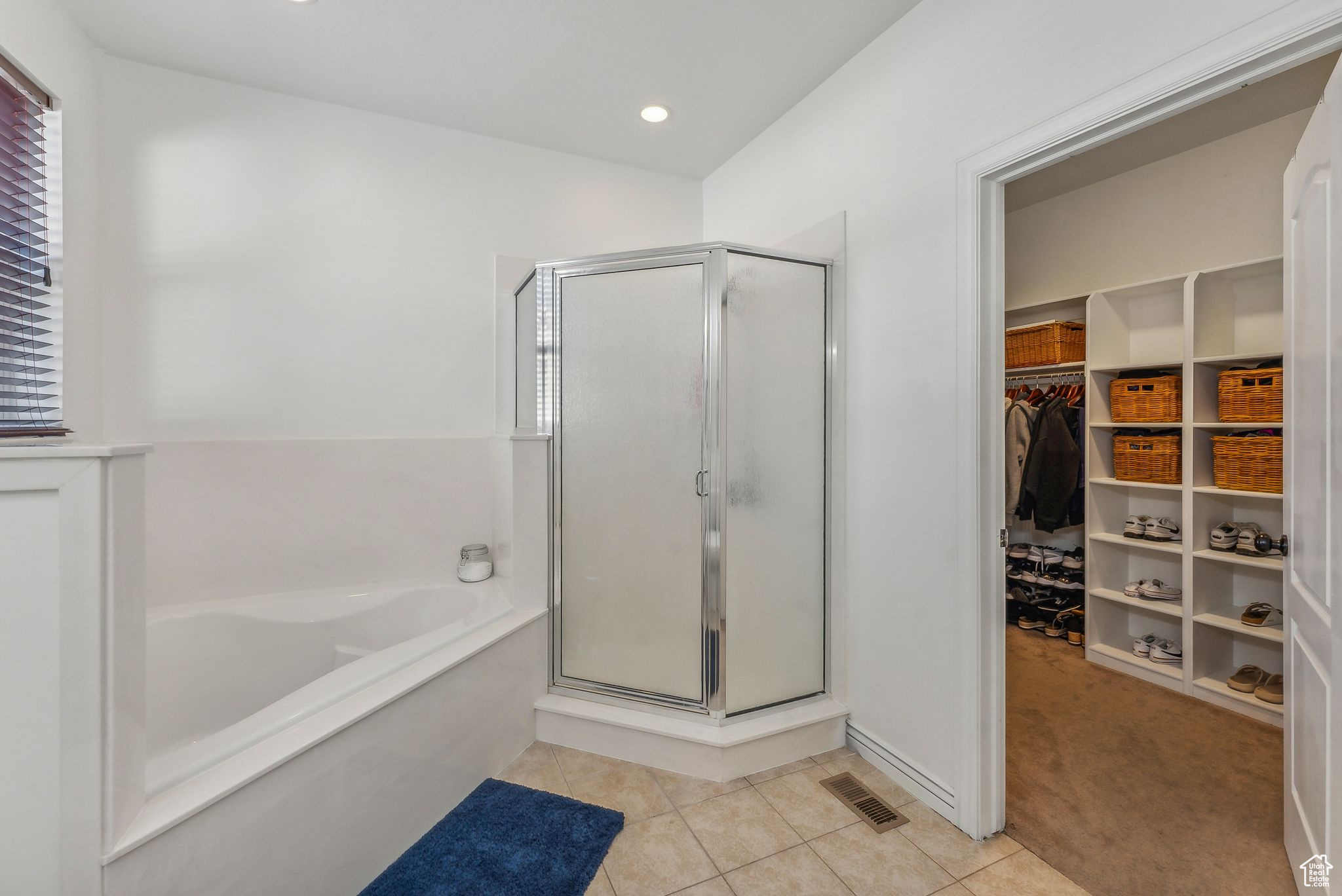 Bathroom with tile patterned flooring, separate shower and tub, and plenty of natural light