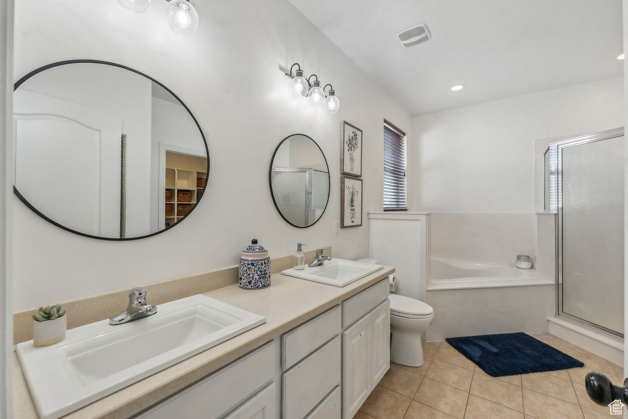 Full bathroom with plus walk in shower, tile patterned flooring, toilet, and dual bowl vanity