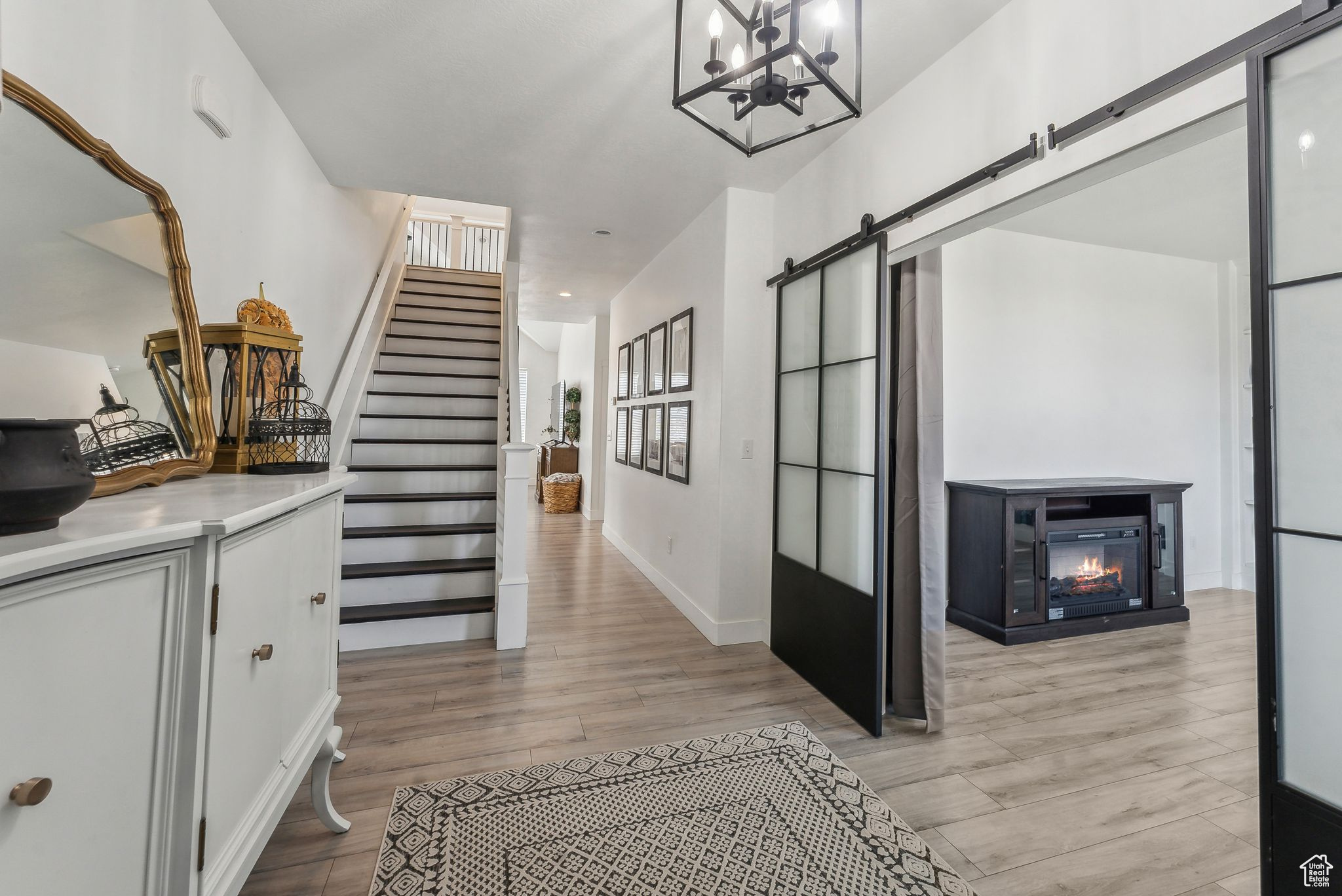 Interior space featuring a chandelier, light hardwood / wood-style flooring, and a barn door