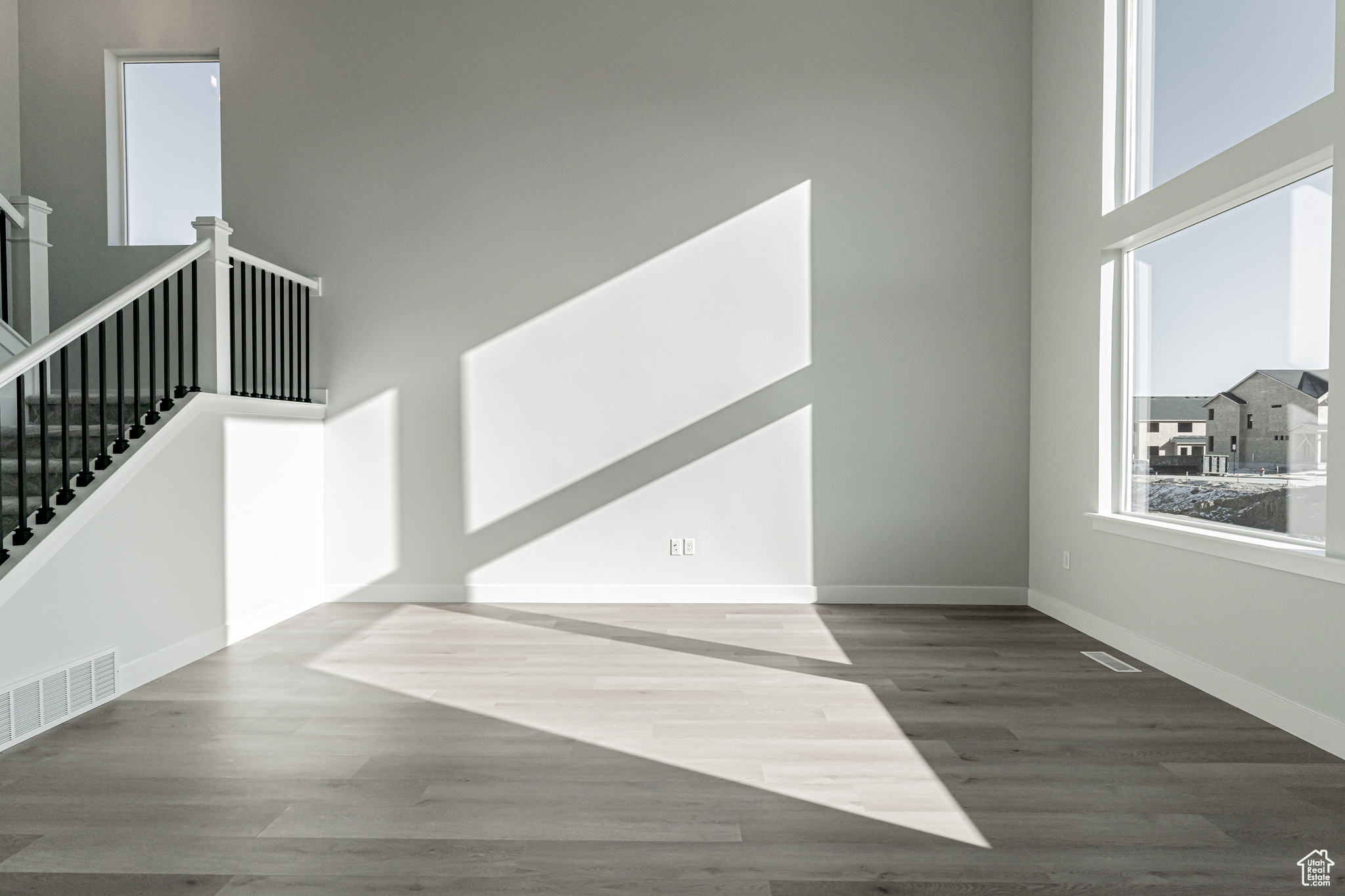 Interior space with hardwood / wood-style floors and a high ceiling