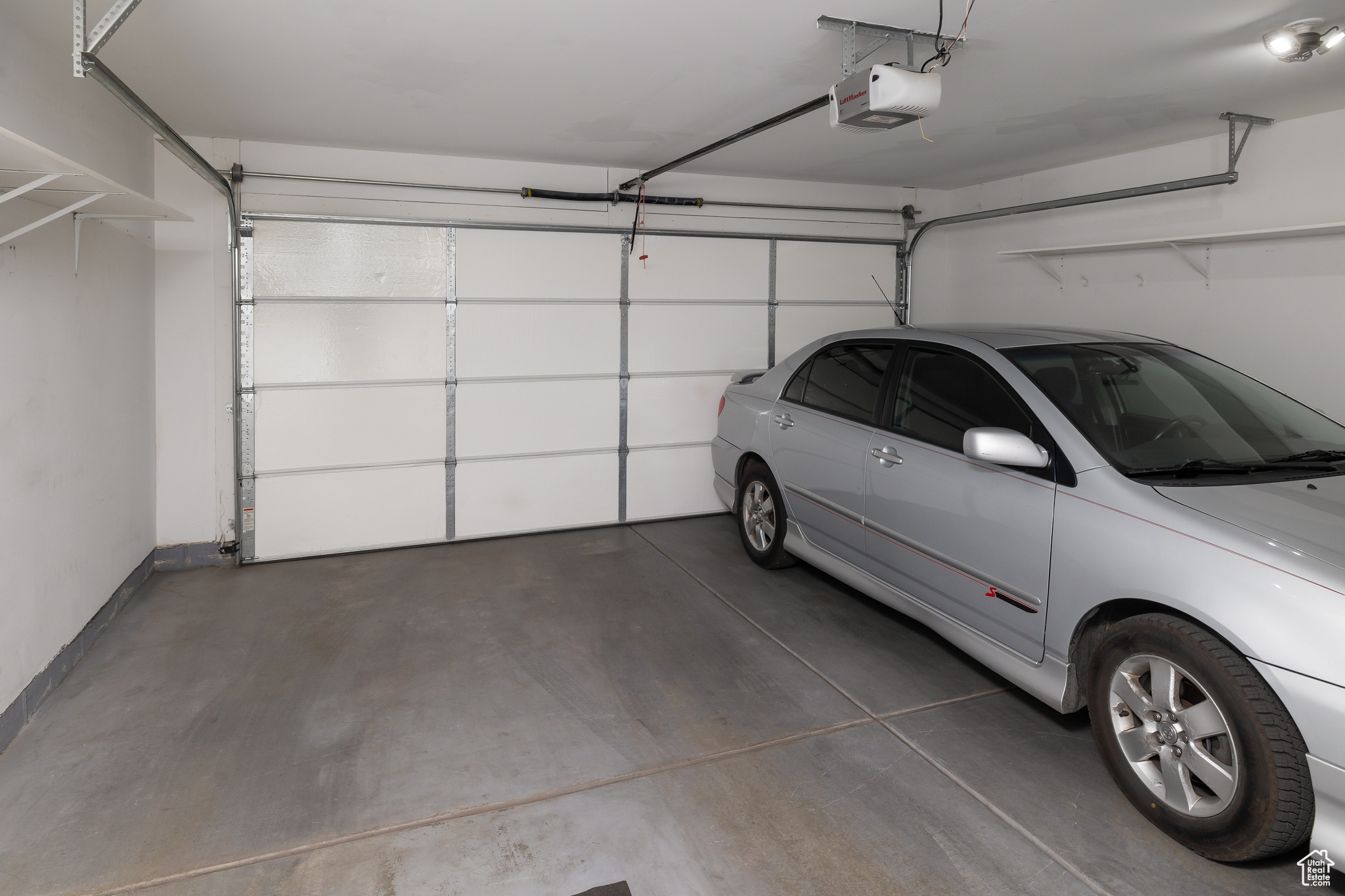 Garage featuring a garage door opener