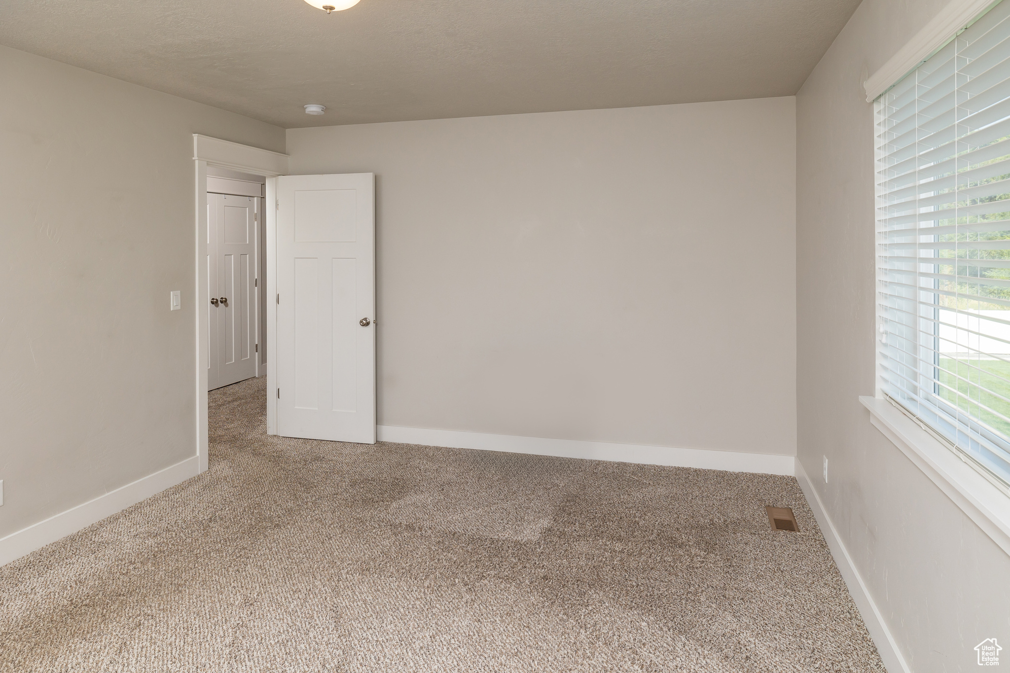 Empty room featuring carpet flooring