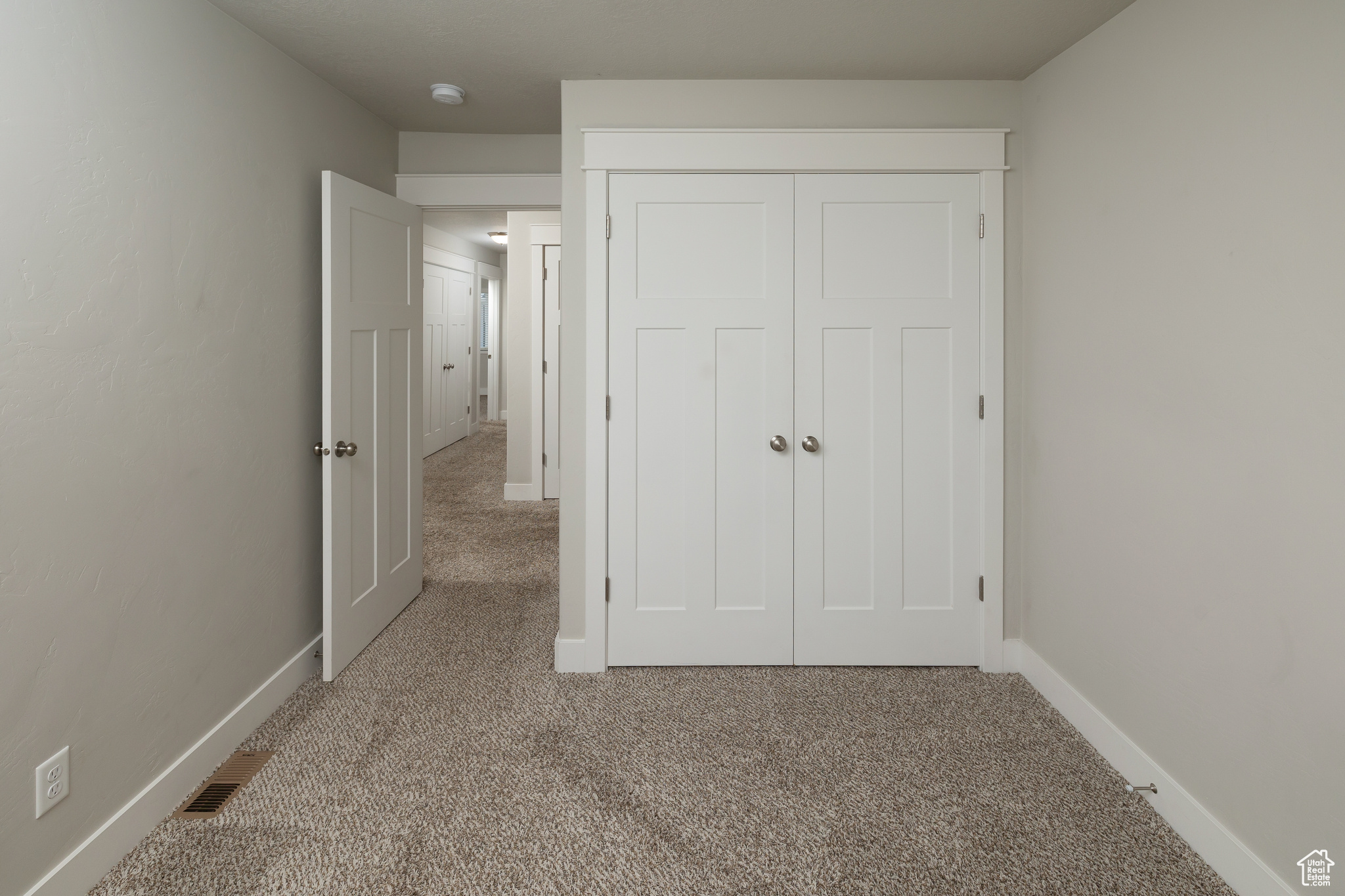 Unfurnished bedroom with a closet and carpet floors