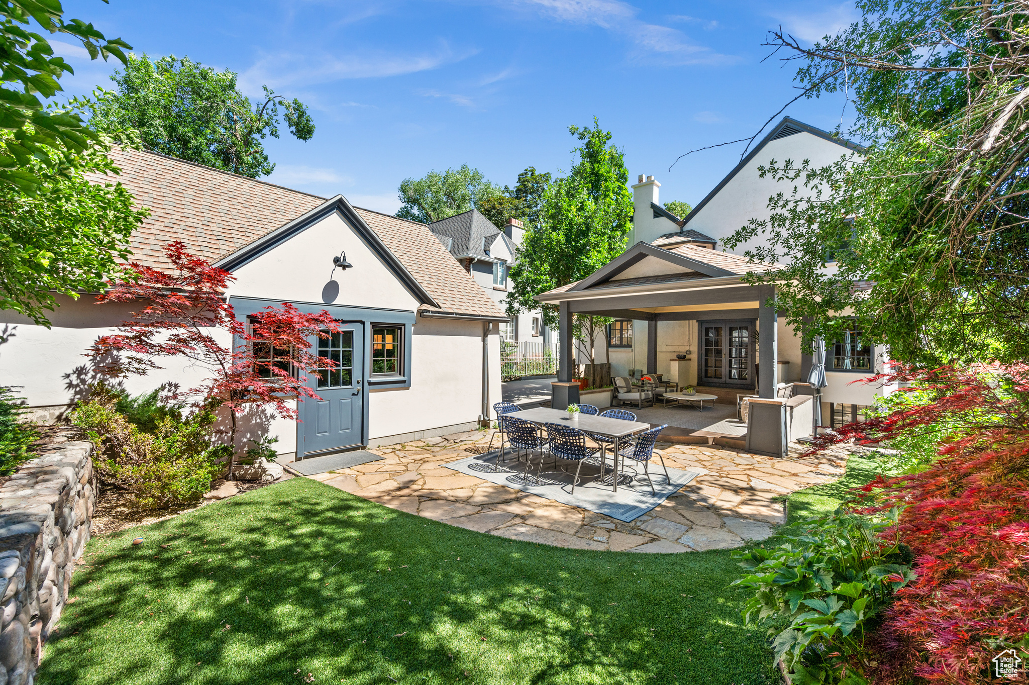 Rear view of property featuring a patio area and a lawn