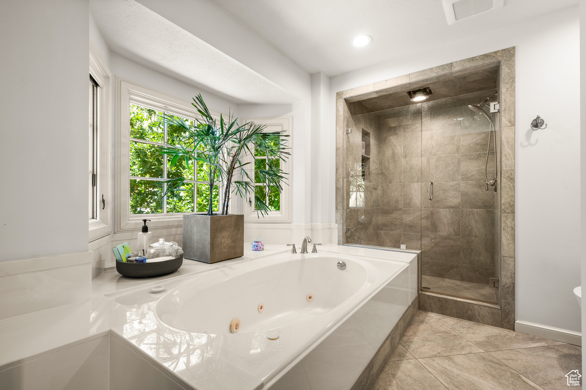 Bathroom with tile patterned floors and plus walk in shower