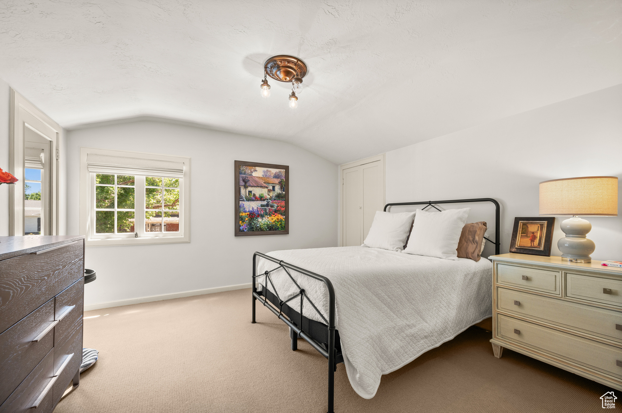 Bedroom with lofted ceiling and carpet flooring