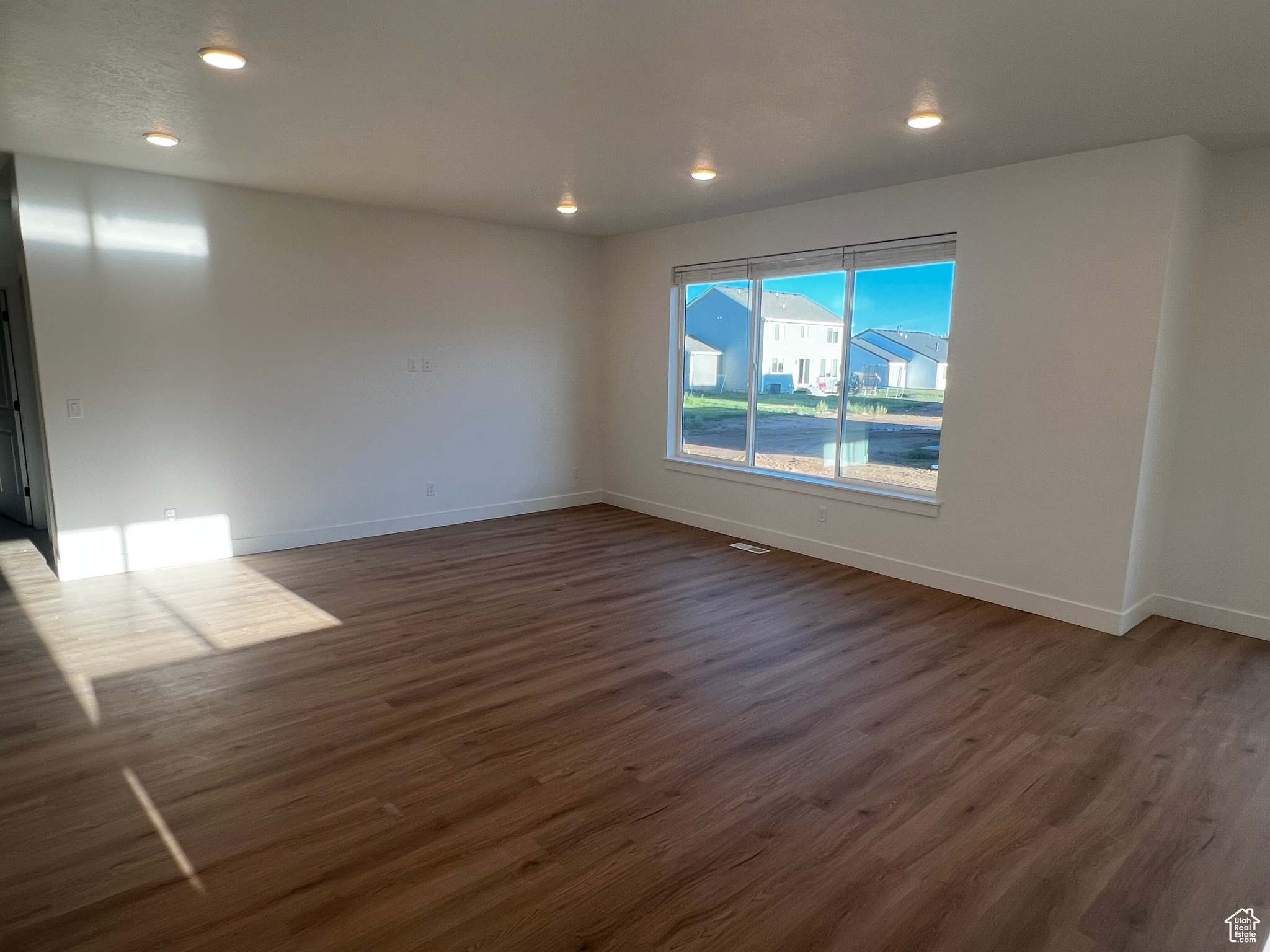 Unfurnished room featuring dark hardwood / wood-style floors