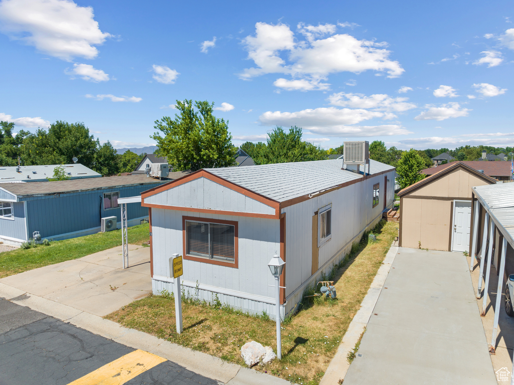 View of front facade featuring a garage and an outbuilding