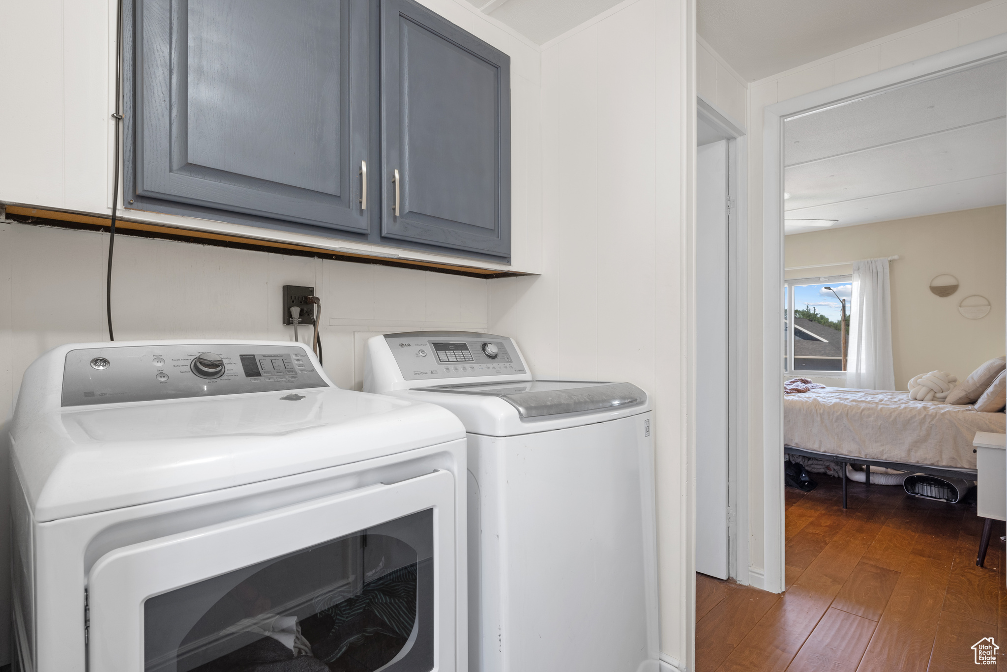 Washroom with cabinets, washer and clothes dryer, and hardwood / wood-style floors