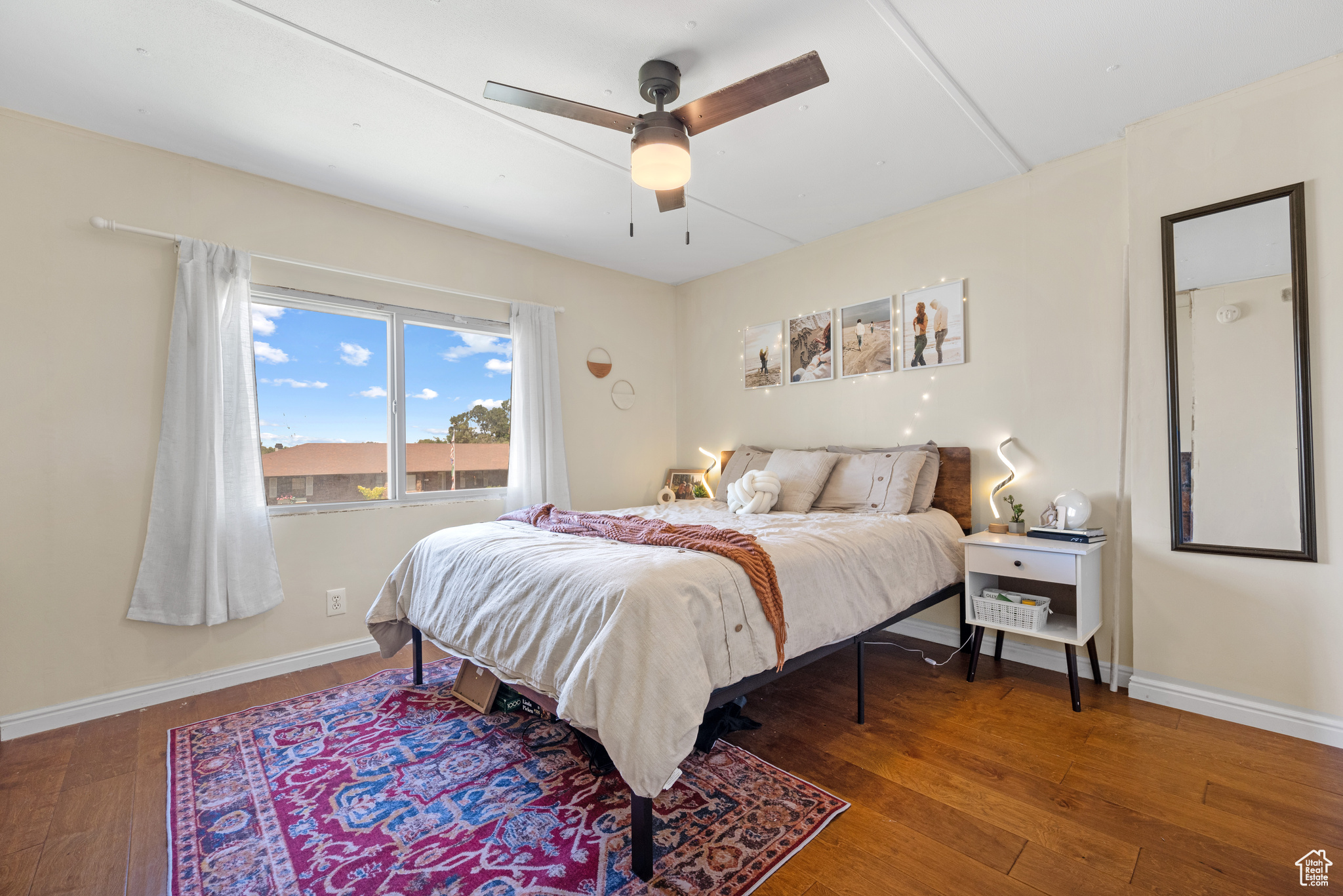 Bedroom featuring ceiling fan and hardwood / wood-style floors