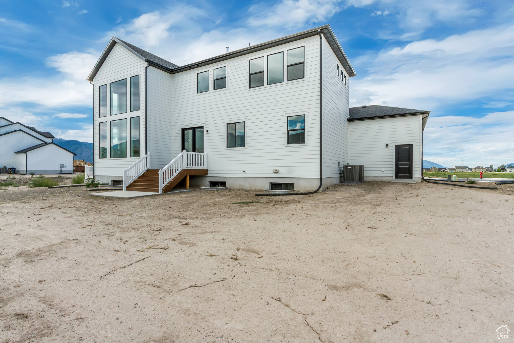 Back of house with central AC unit