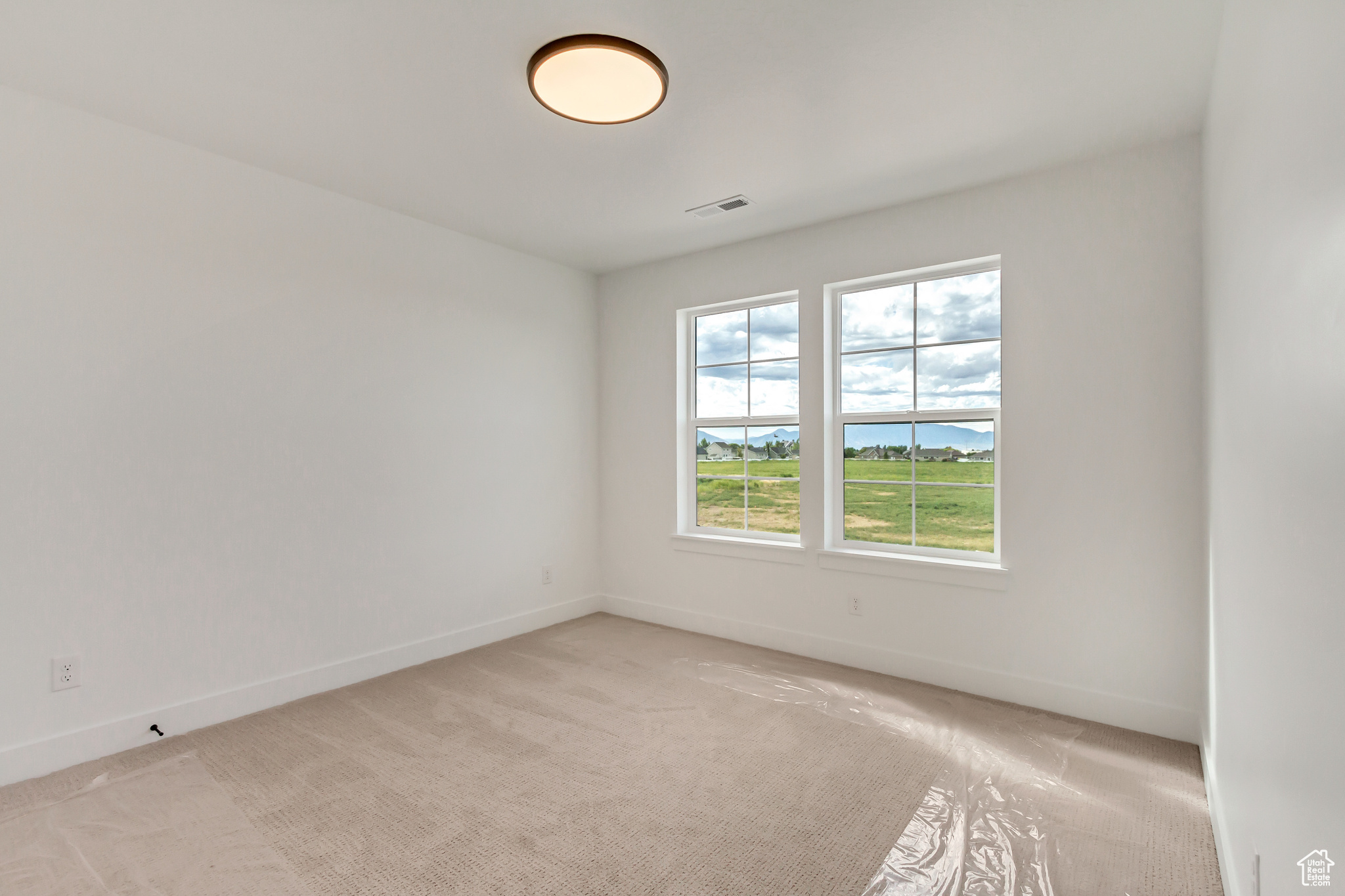 Spare room with light carpet