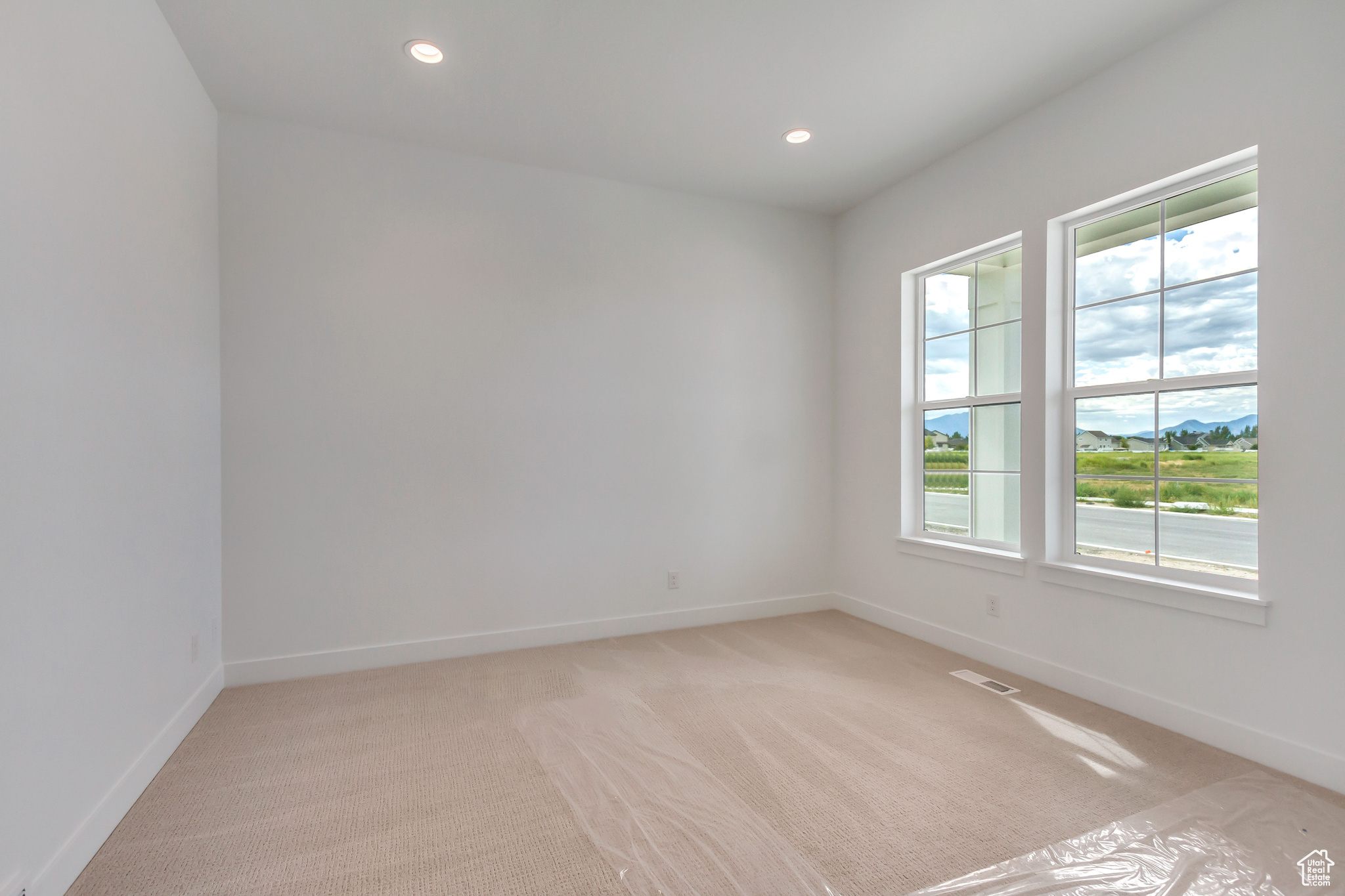 Carpeted spare room with plenty of natural light