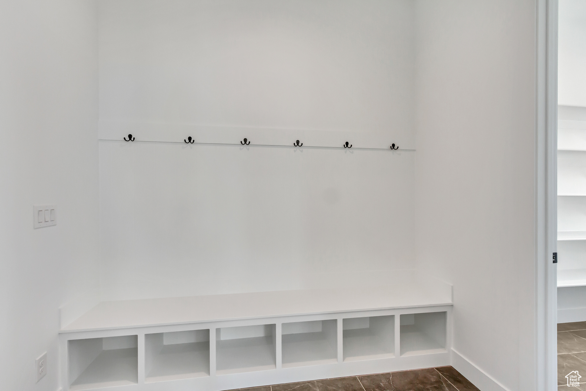 Mudroom with tile patterned flooring