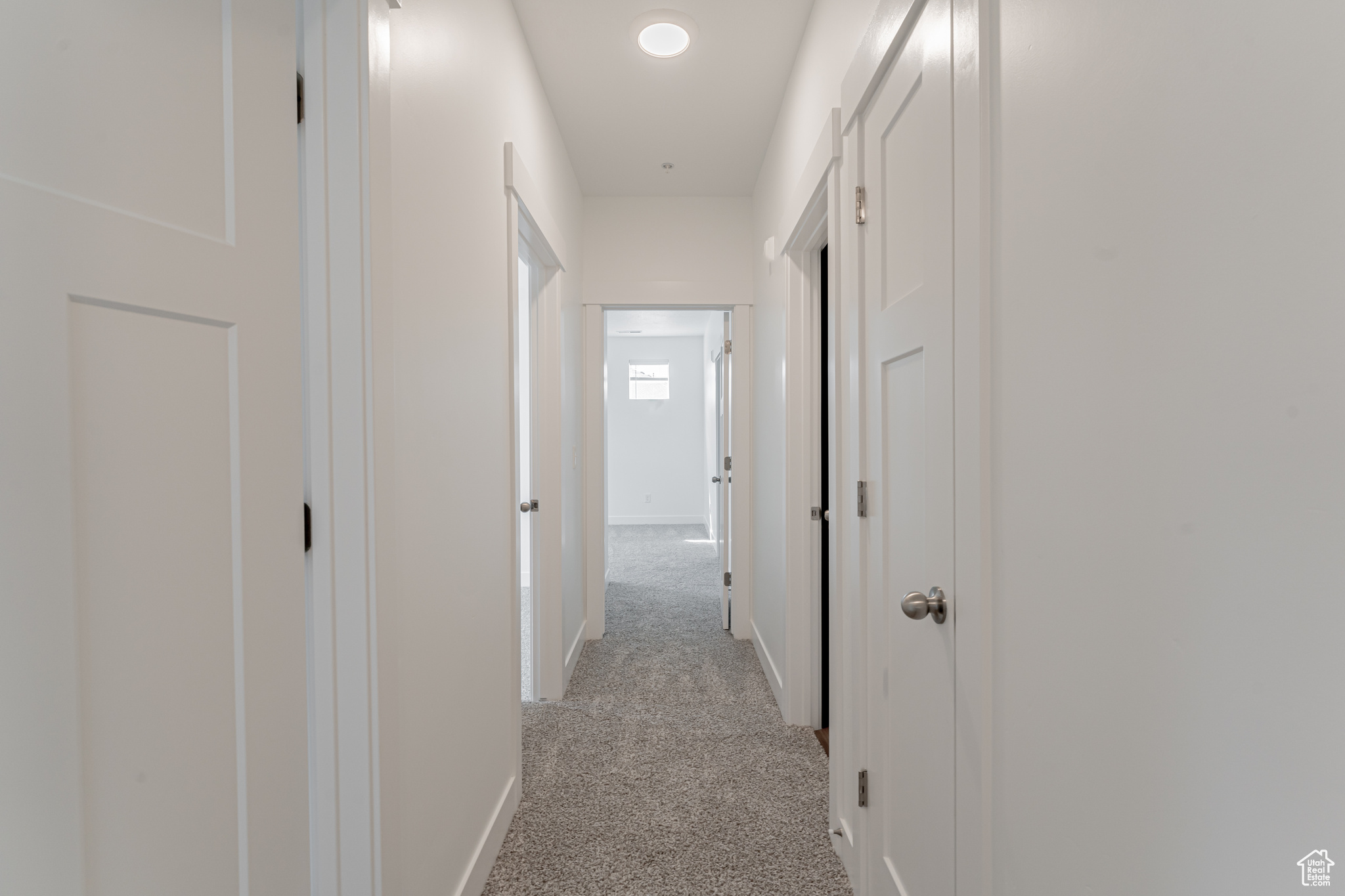 Hallway with light carpet