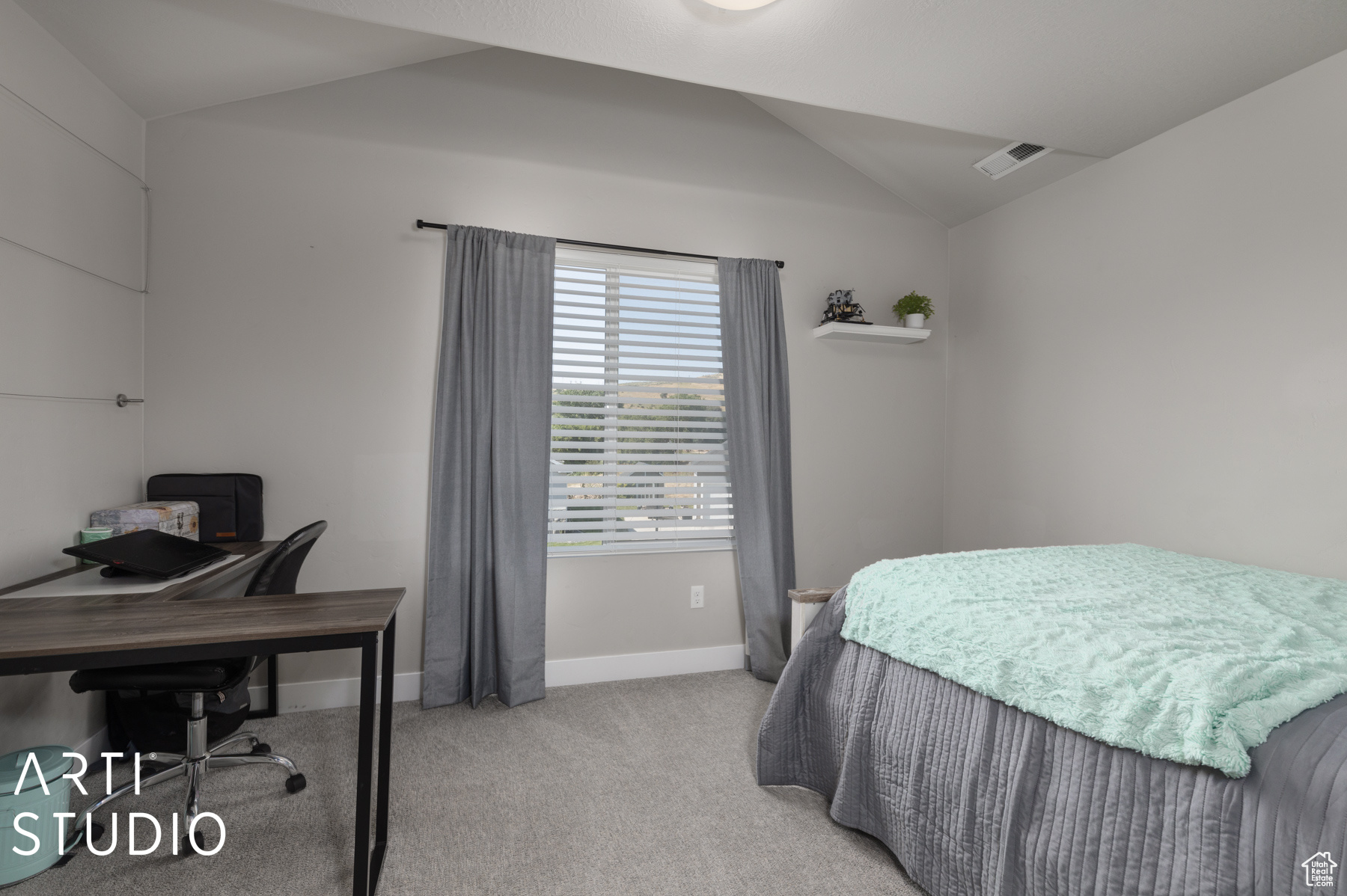 Bedroom with carpet and vaulted ceiling