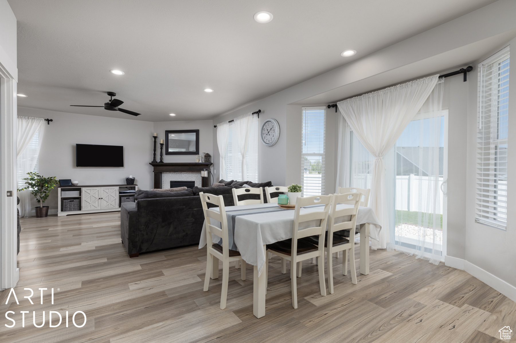 Dining space with ceiling fan and light hardwood / wood-style floors