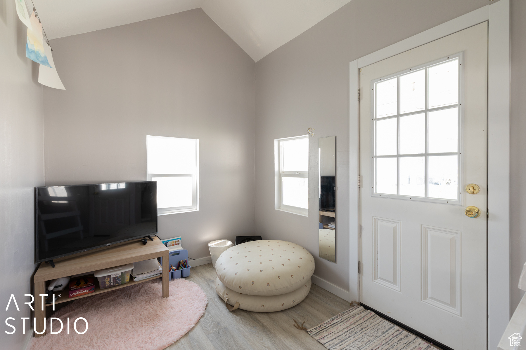 Playhouse with lofted ceiling and hardwood / wood-style floors