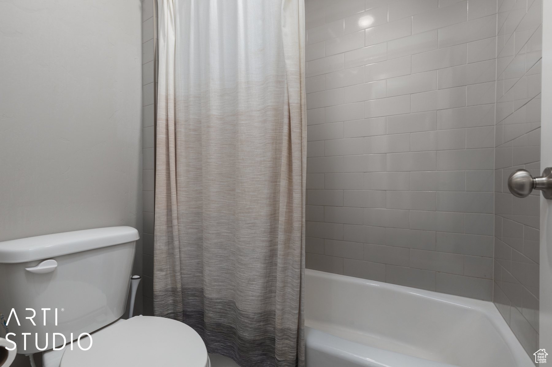 Bathroom with toilet and shower / bath combo