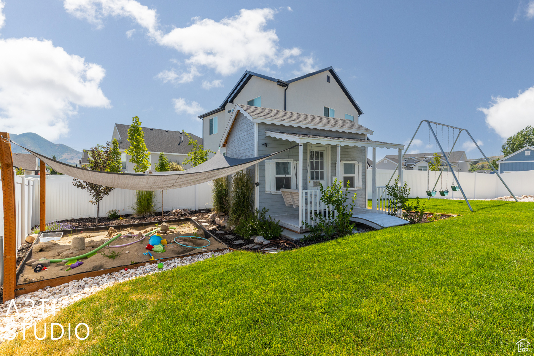 Rear view of property featuring a playhouse