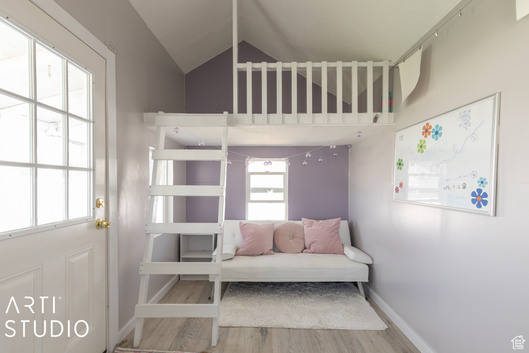 Playhouse featuring lofted ceiling and wood-type flooring