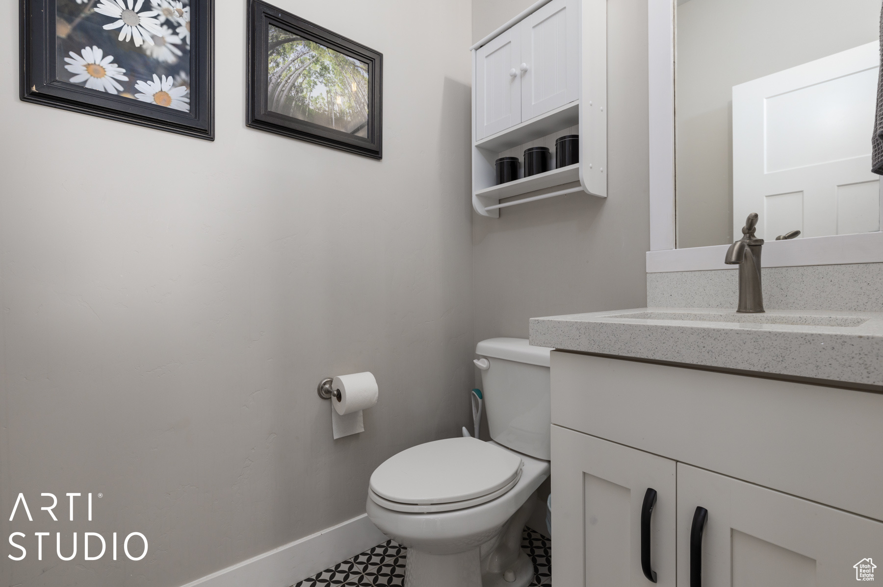 Bathroom with vanity, toilet, and tile patterned flooring