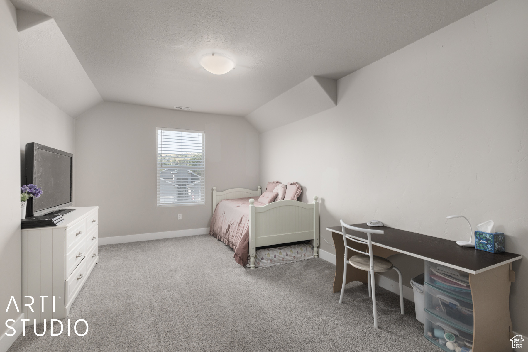 Carpeted bedroom with lofted ceiling