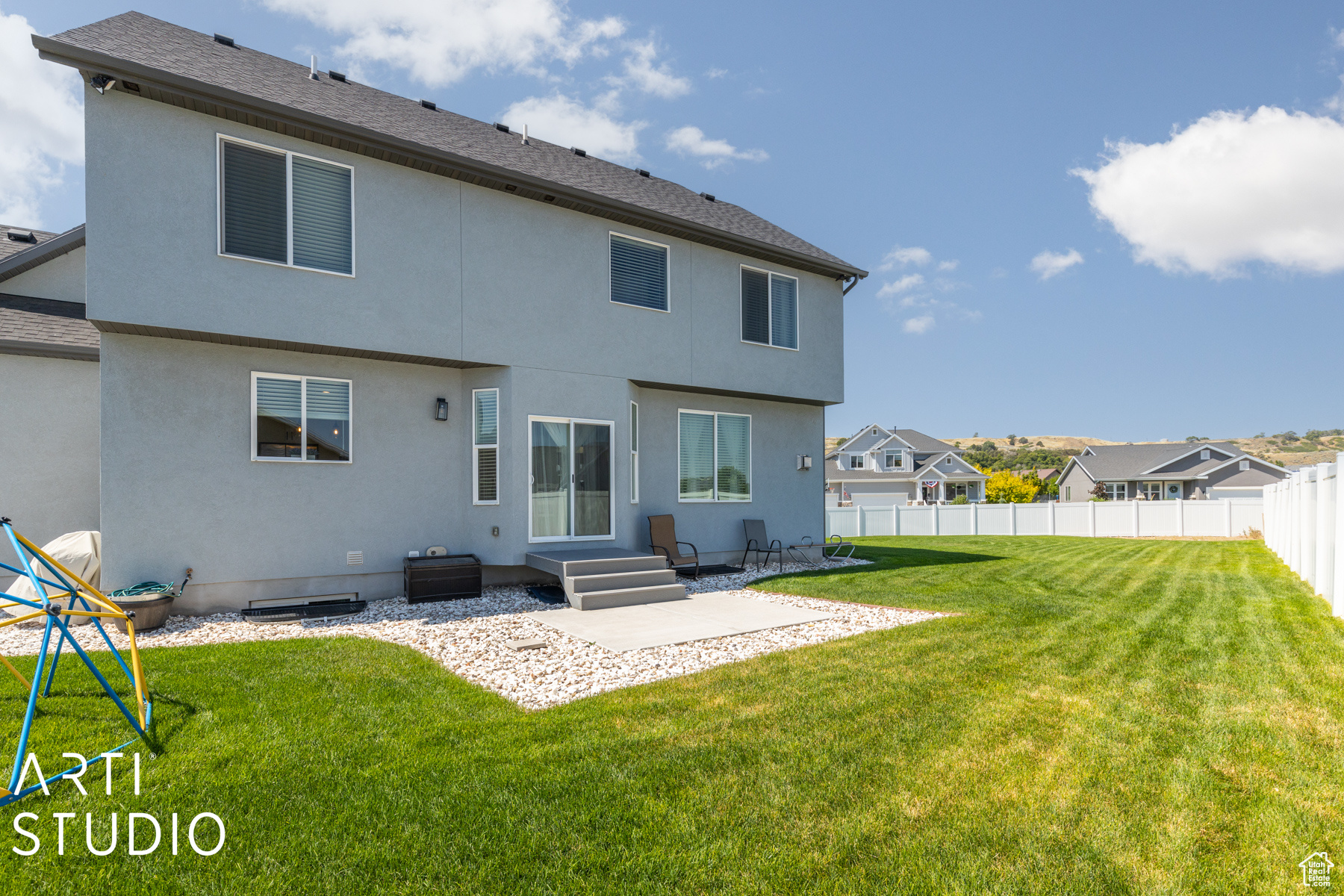 Rear view of house with a patio area and a lawn