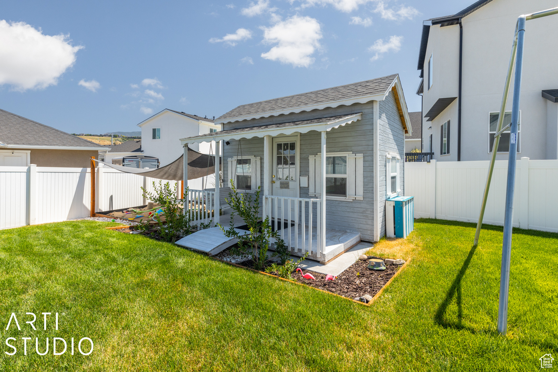 Back of house featuring playhouse