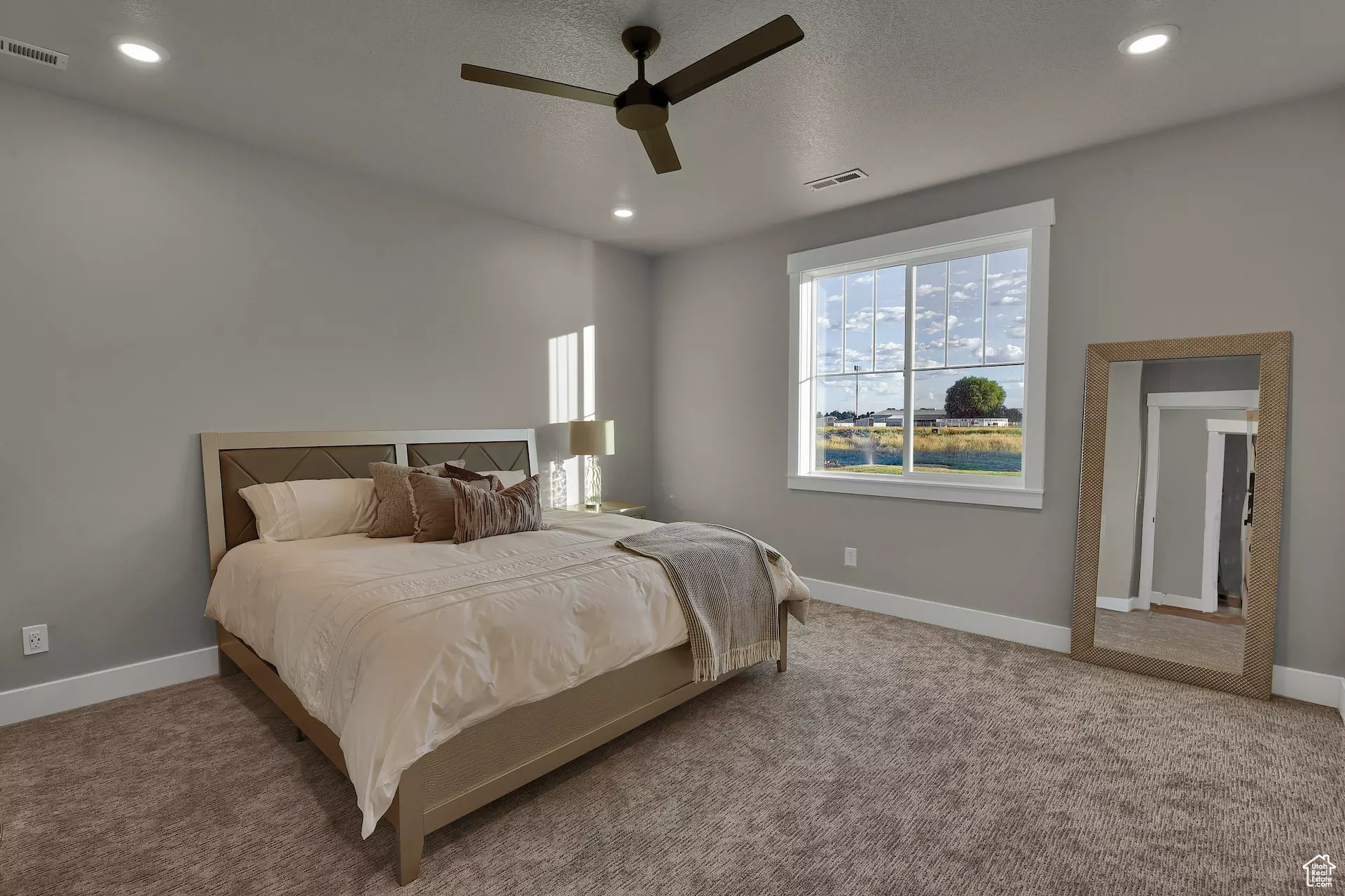 Carpeted bedroom with ceiling fan