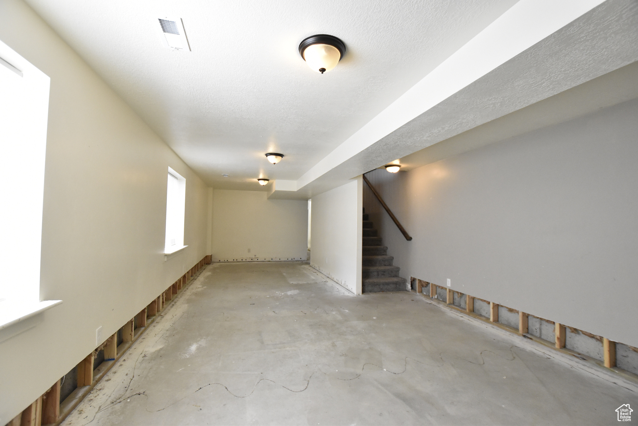 Basement with a textured ceiling