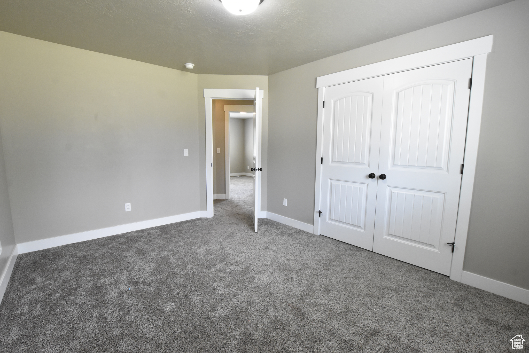 Unfurnished bedroom featuring a closet and carpet floors