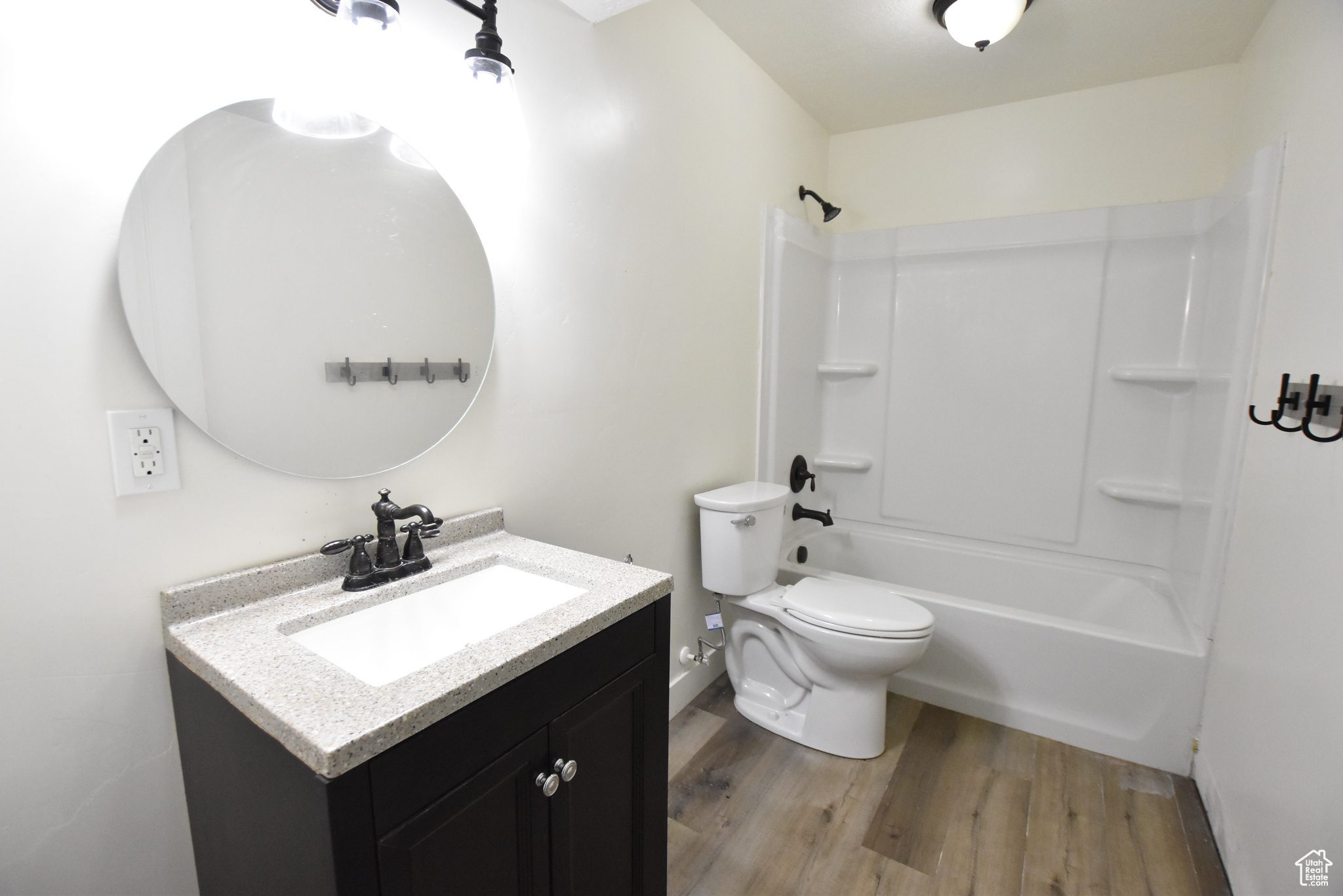 Full bathroom featuring vanity, tub / shower combination, toilet, and hardwood / wood-style floors