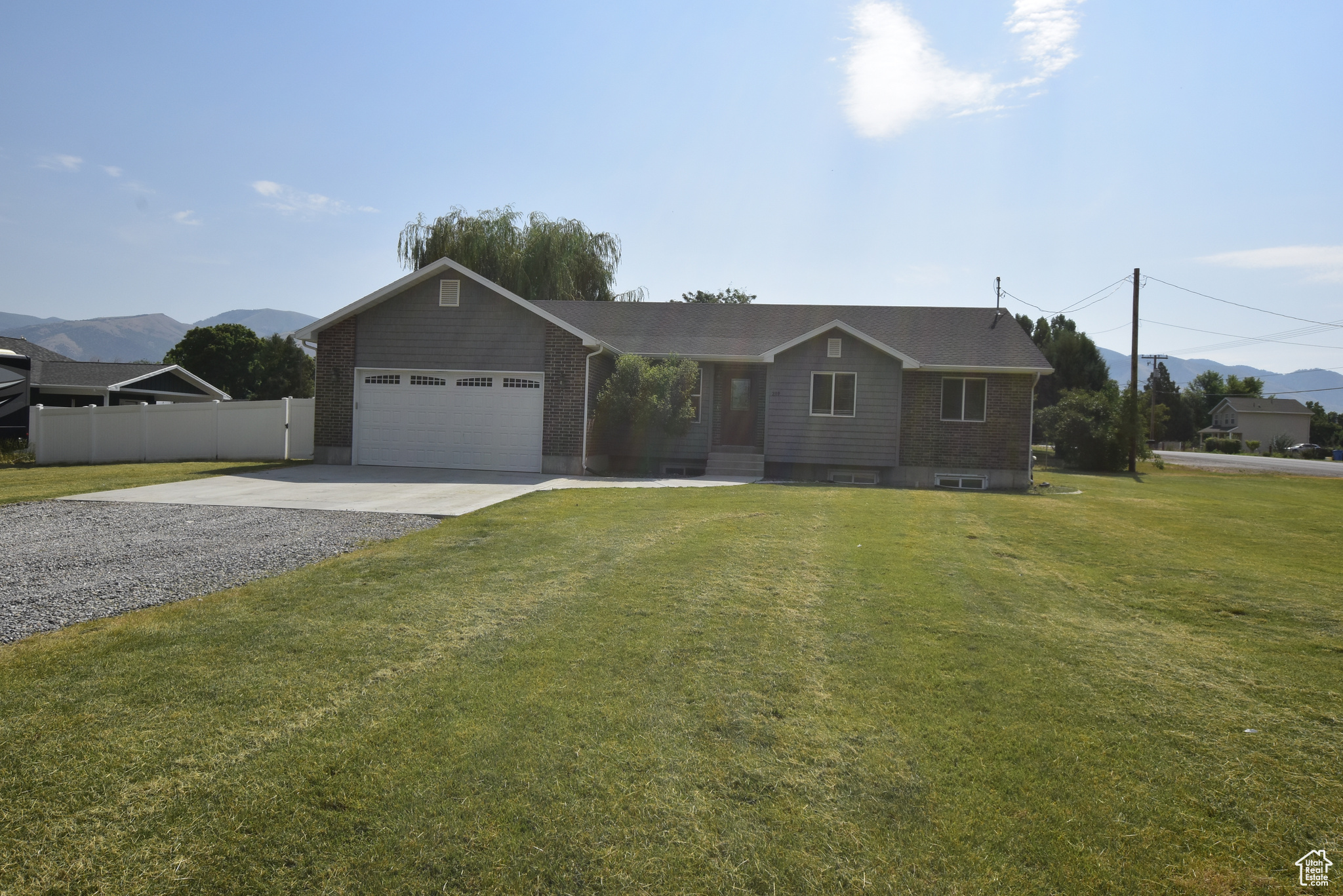 Ranch-style home with a garage and a front yard