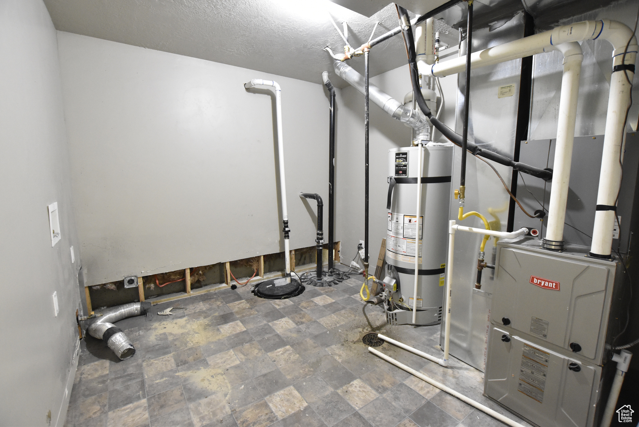 Utility room featuring secured water heater