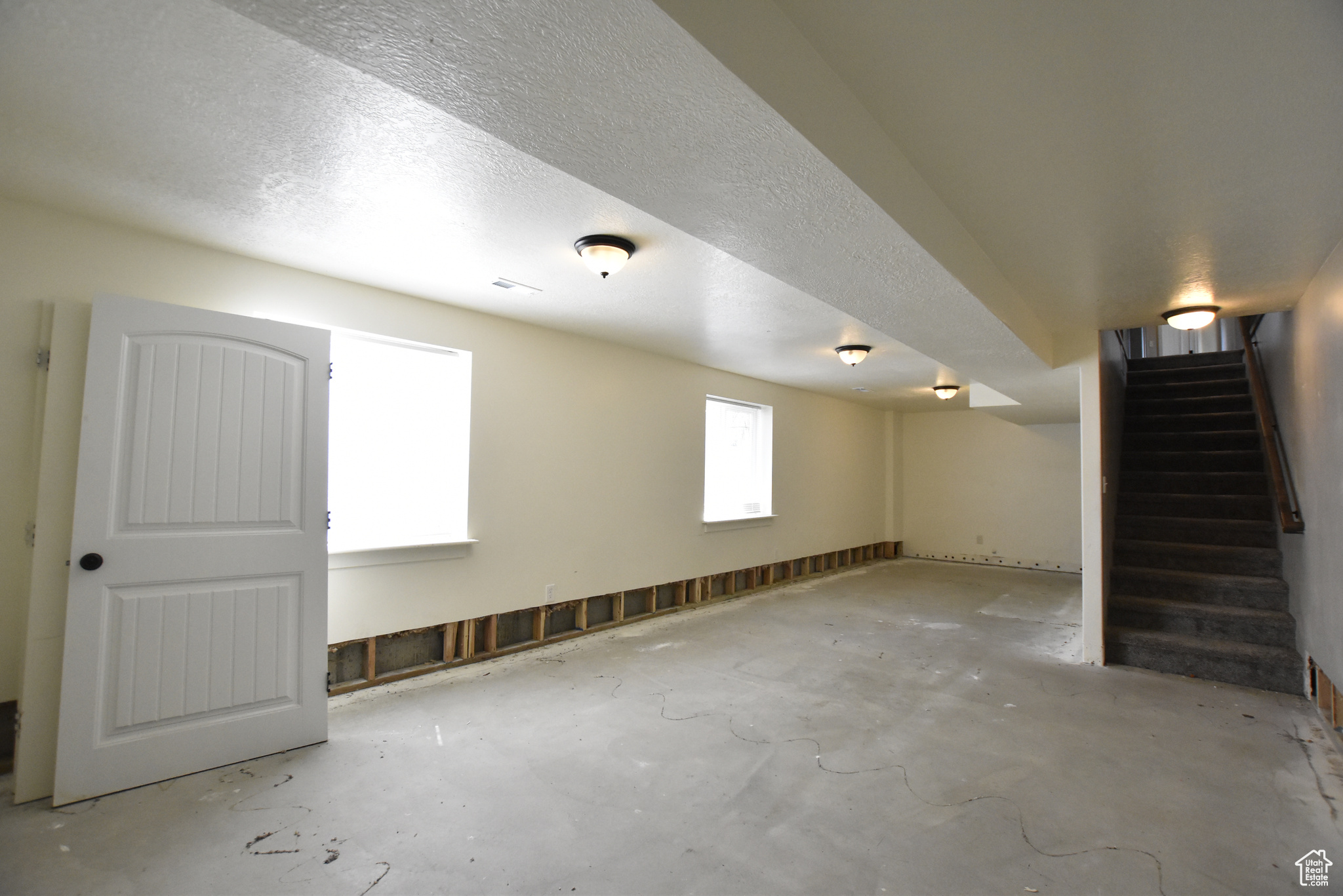 Basement featuring a textured ceiling